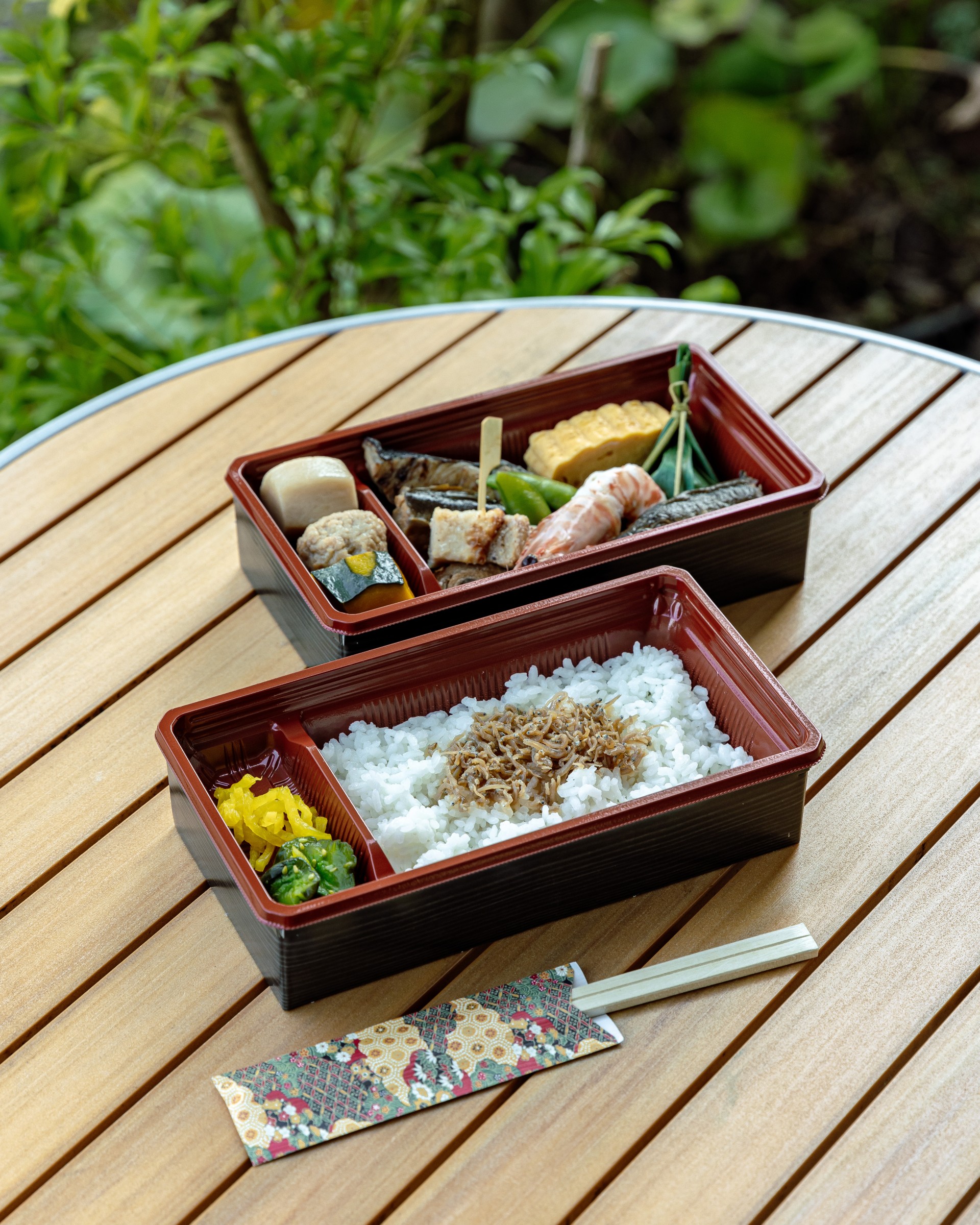 a two rectangular containers of food on a table