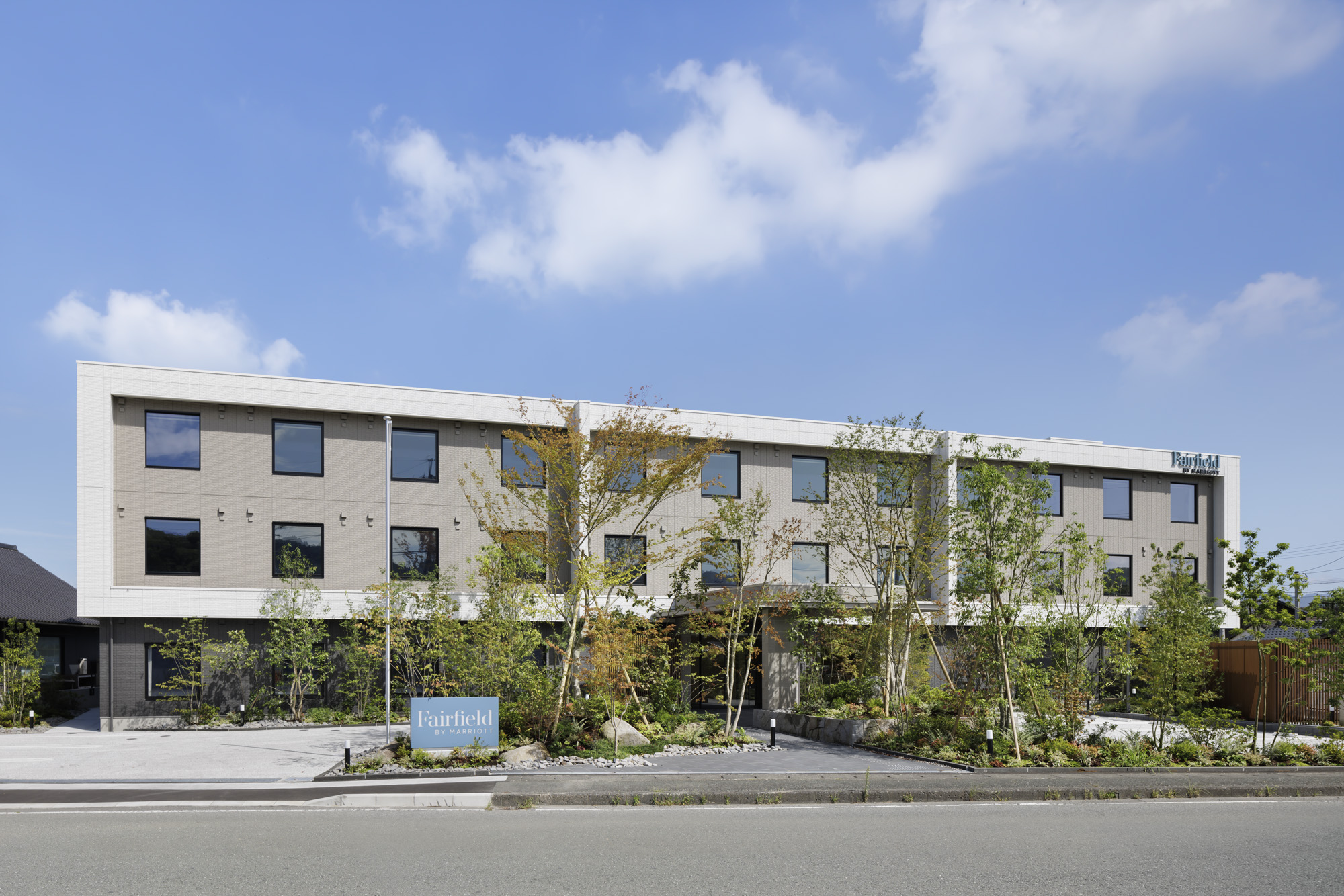 a building with trees and plants in front of it