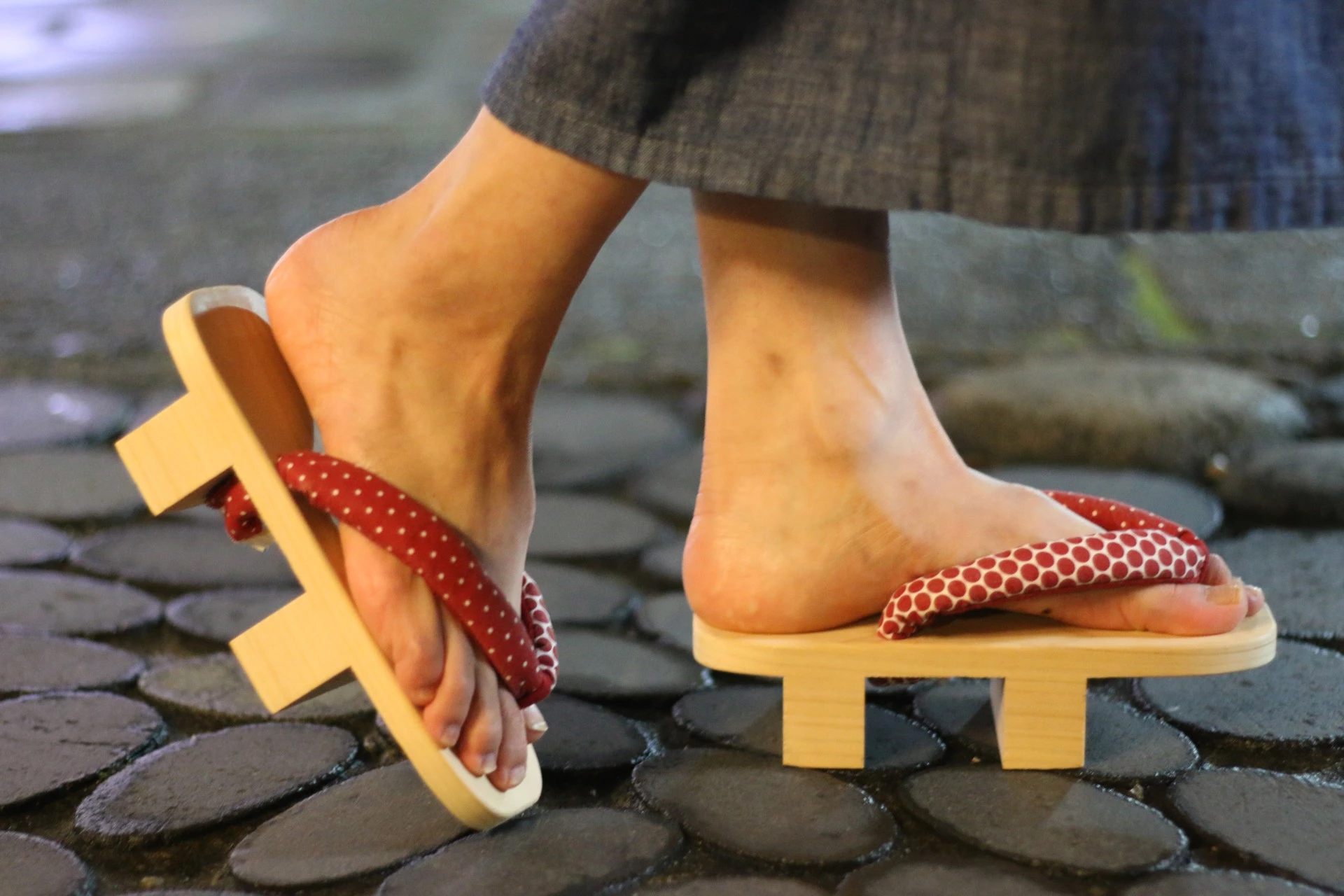 a person wearing sandals on a stone surface