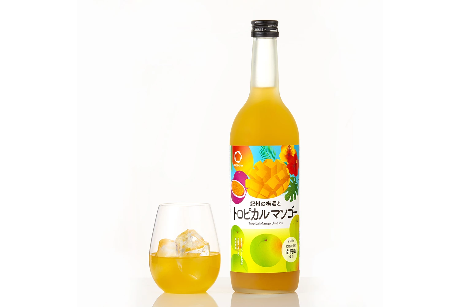 a bottle of yellow liquid next to a glass of yellow liquid