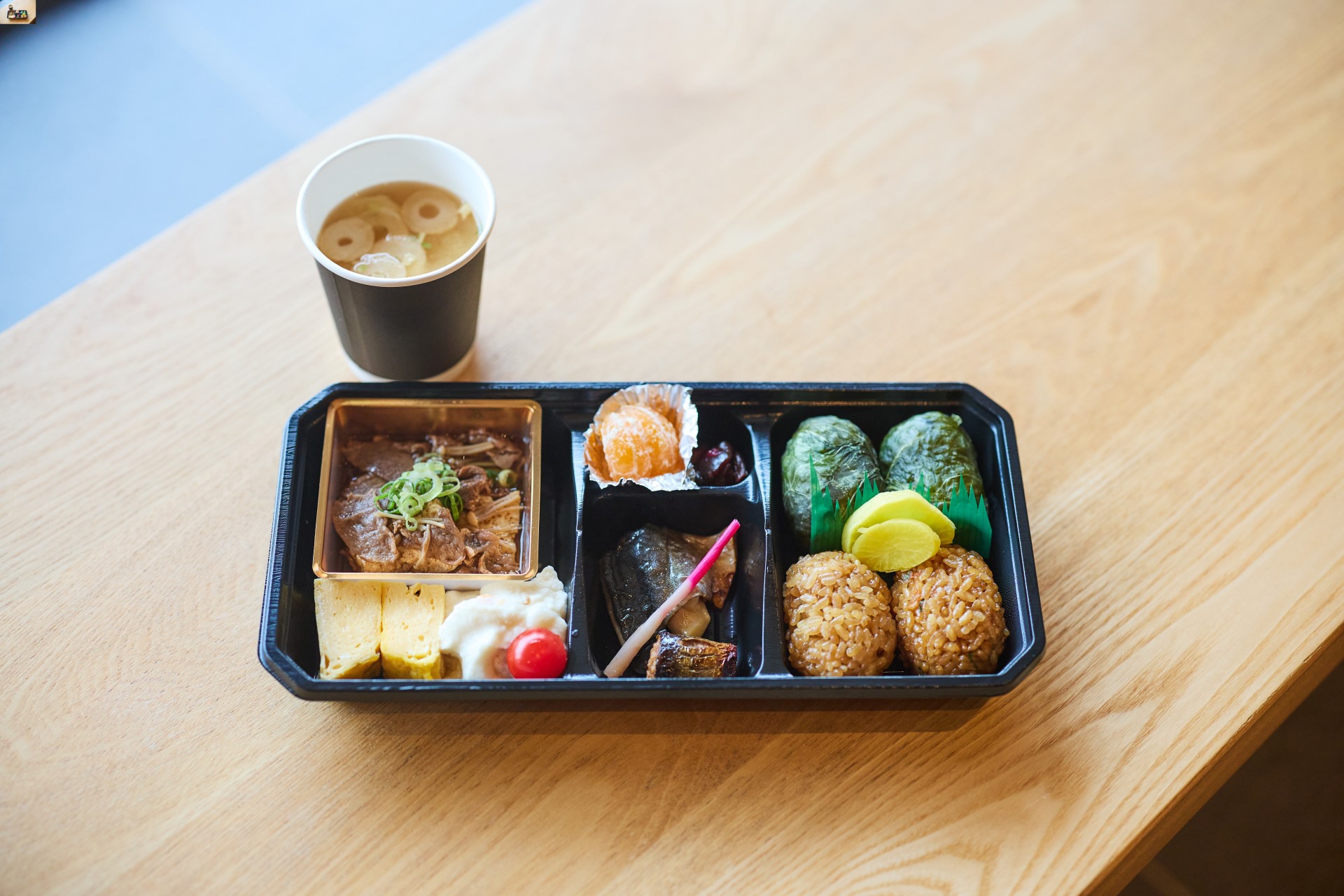 a tray of food and a drink on a table