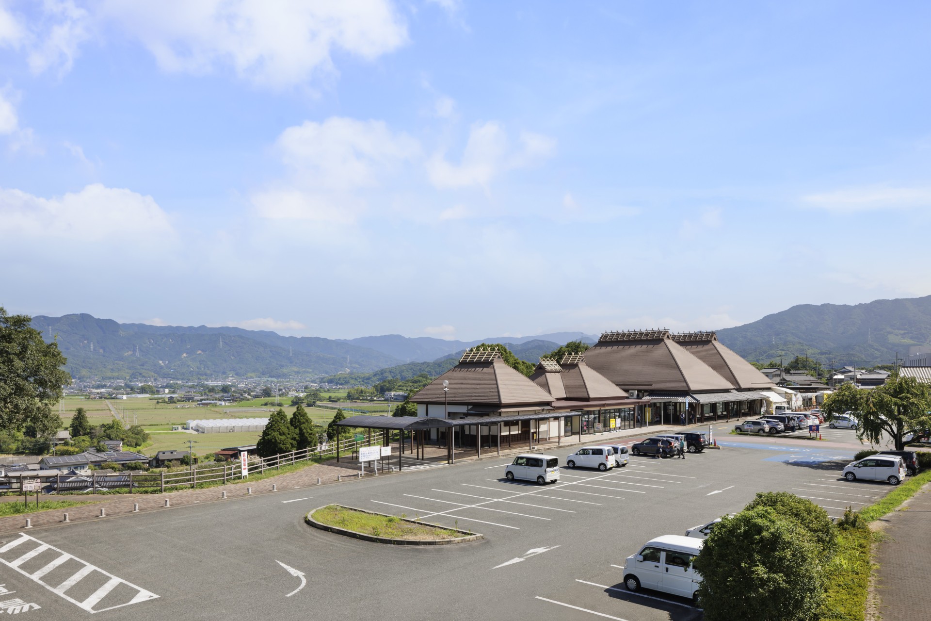 a parking lot with cars and buildings in the background