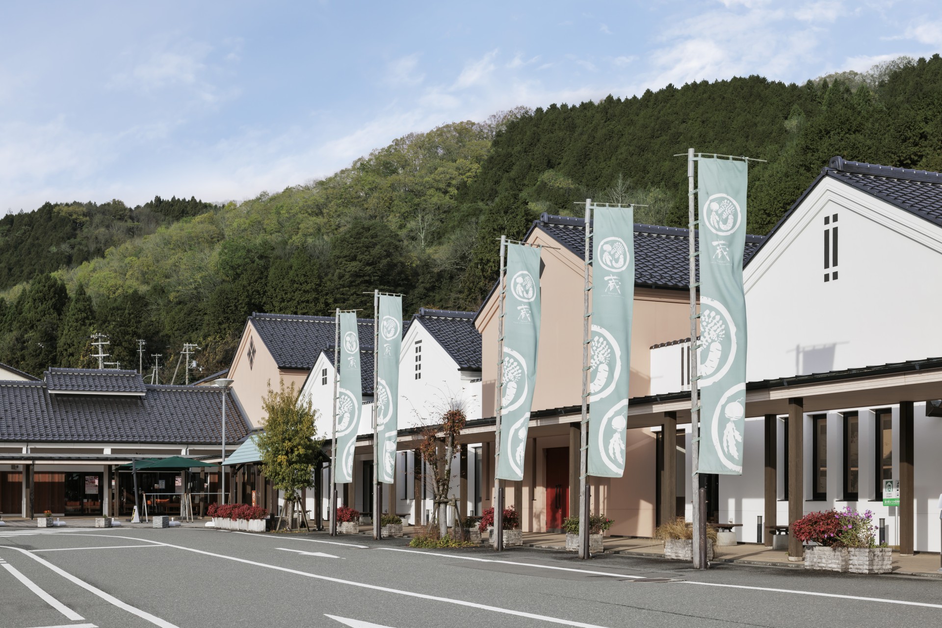 a row of houses with flags on poles
