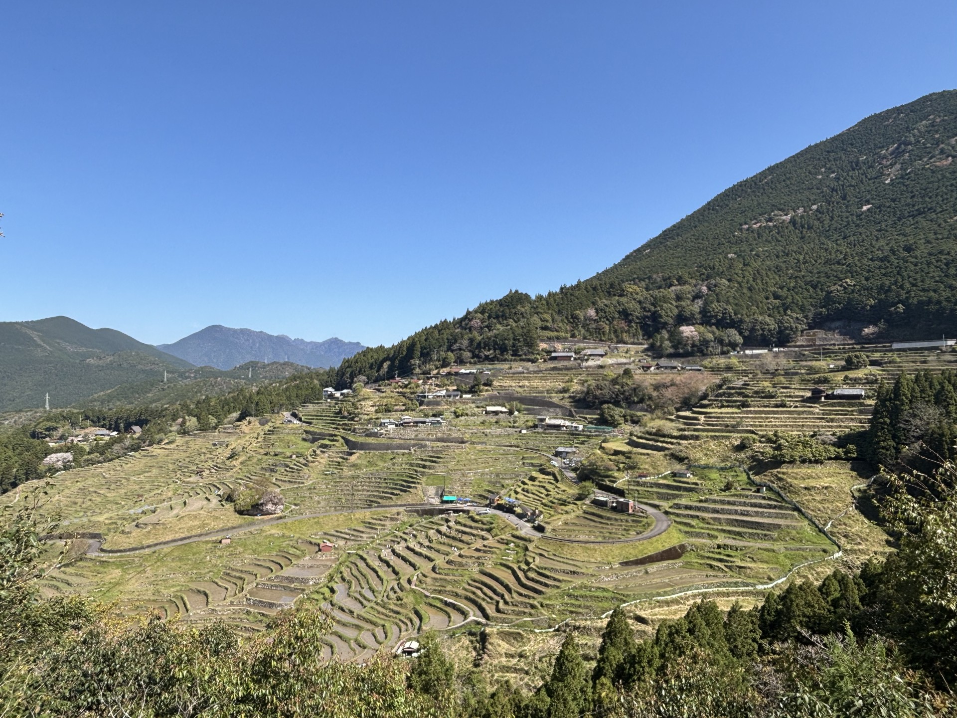 a landscape with a hill and trees and a village