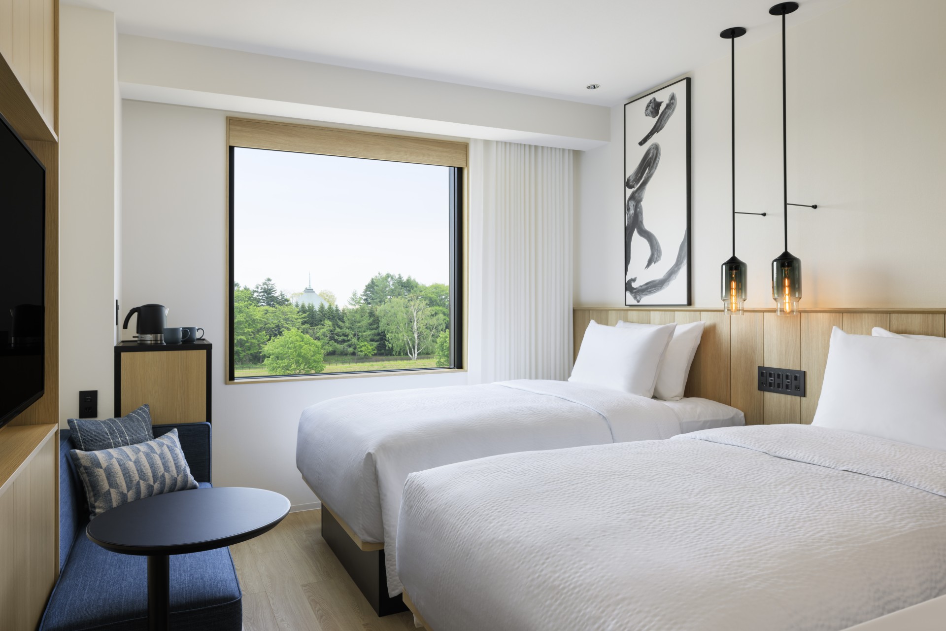 a room with two beds and a window