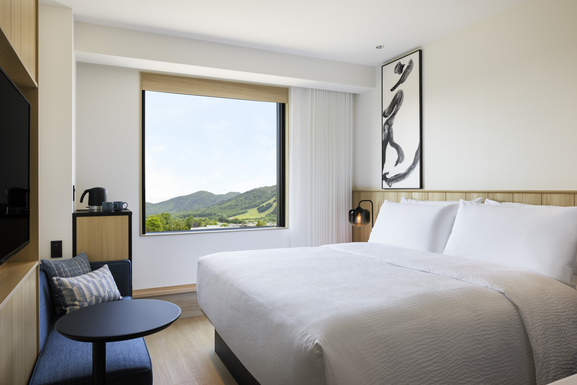 a bedroom with a large window and a bed