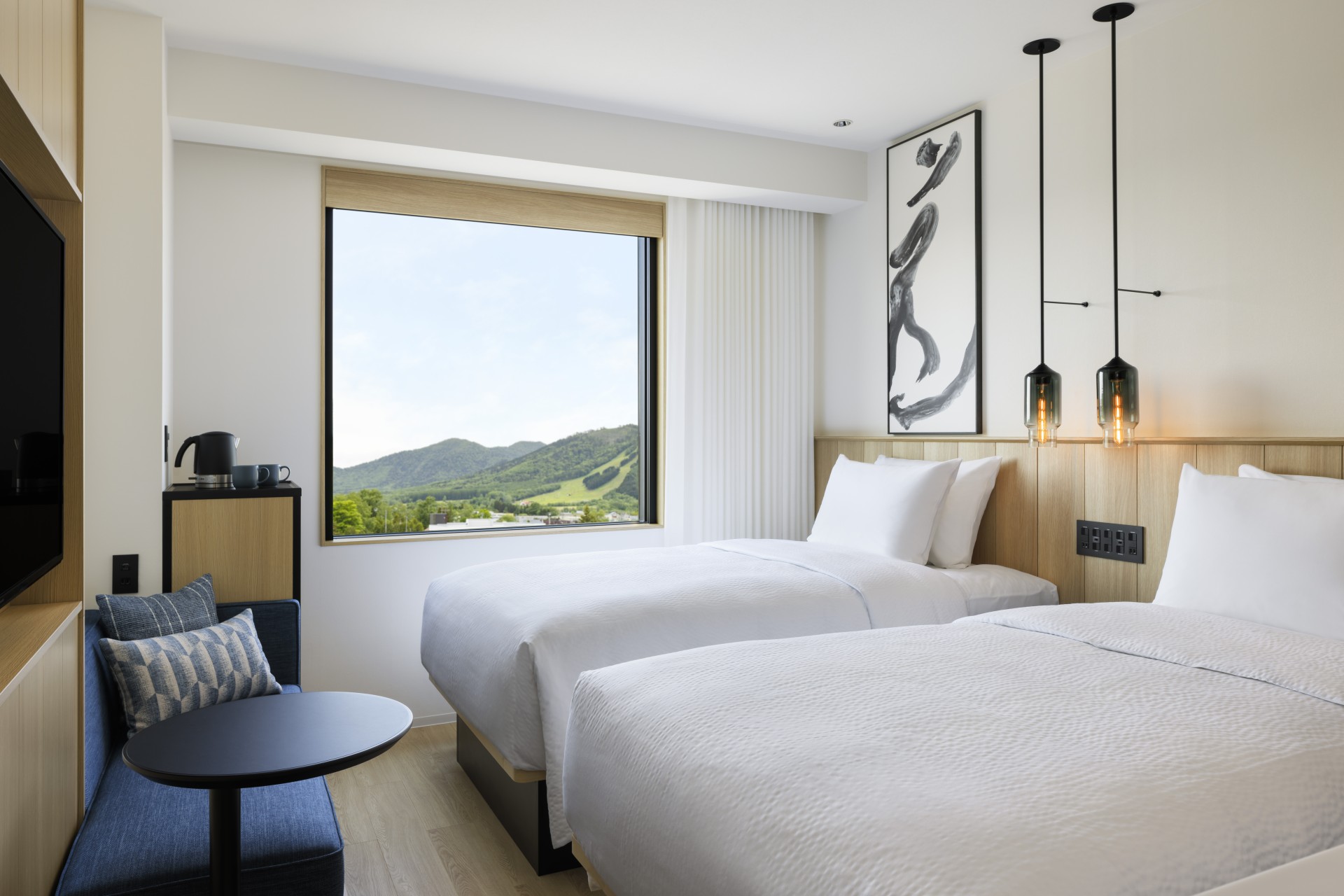 a room with two beds and a window