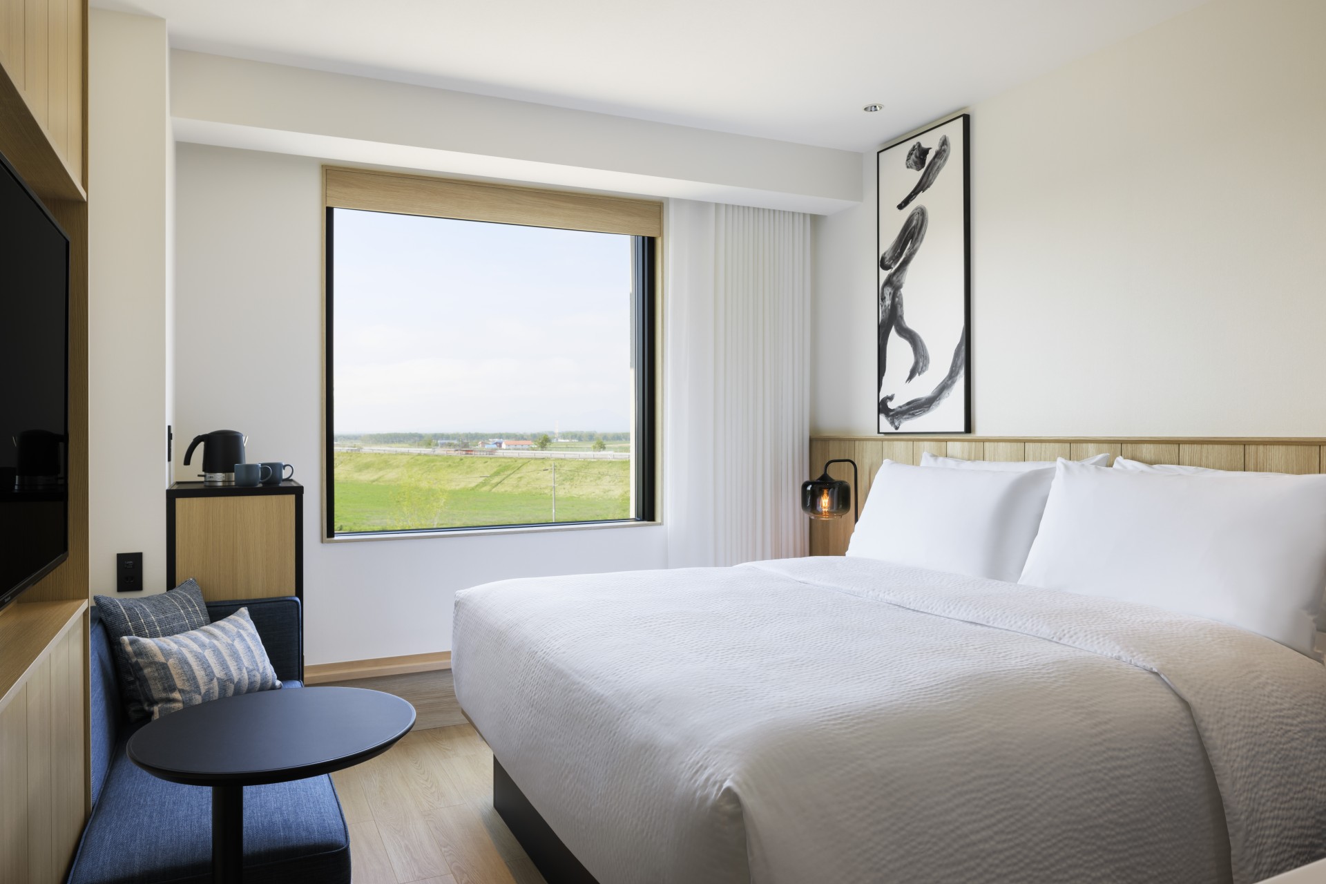 a bed with a window and a chair