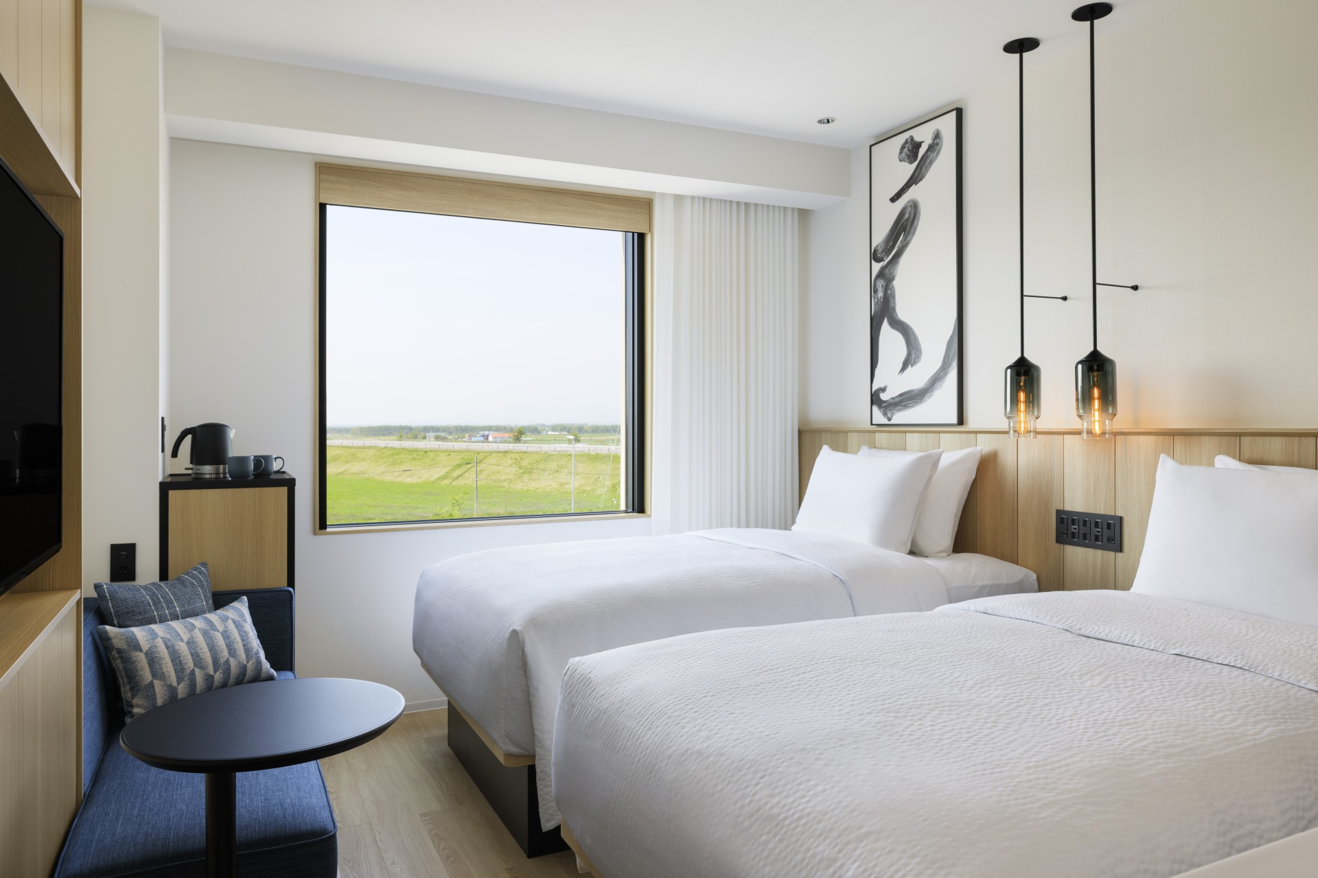 a room with two beds and a window