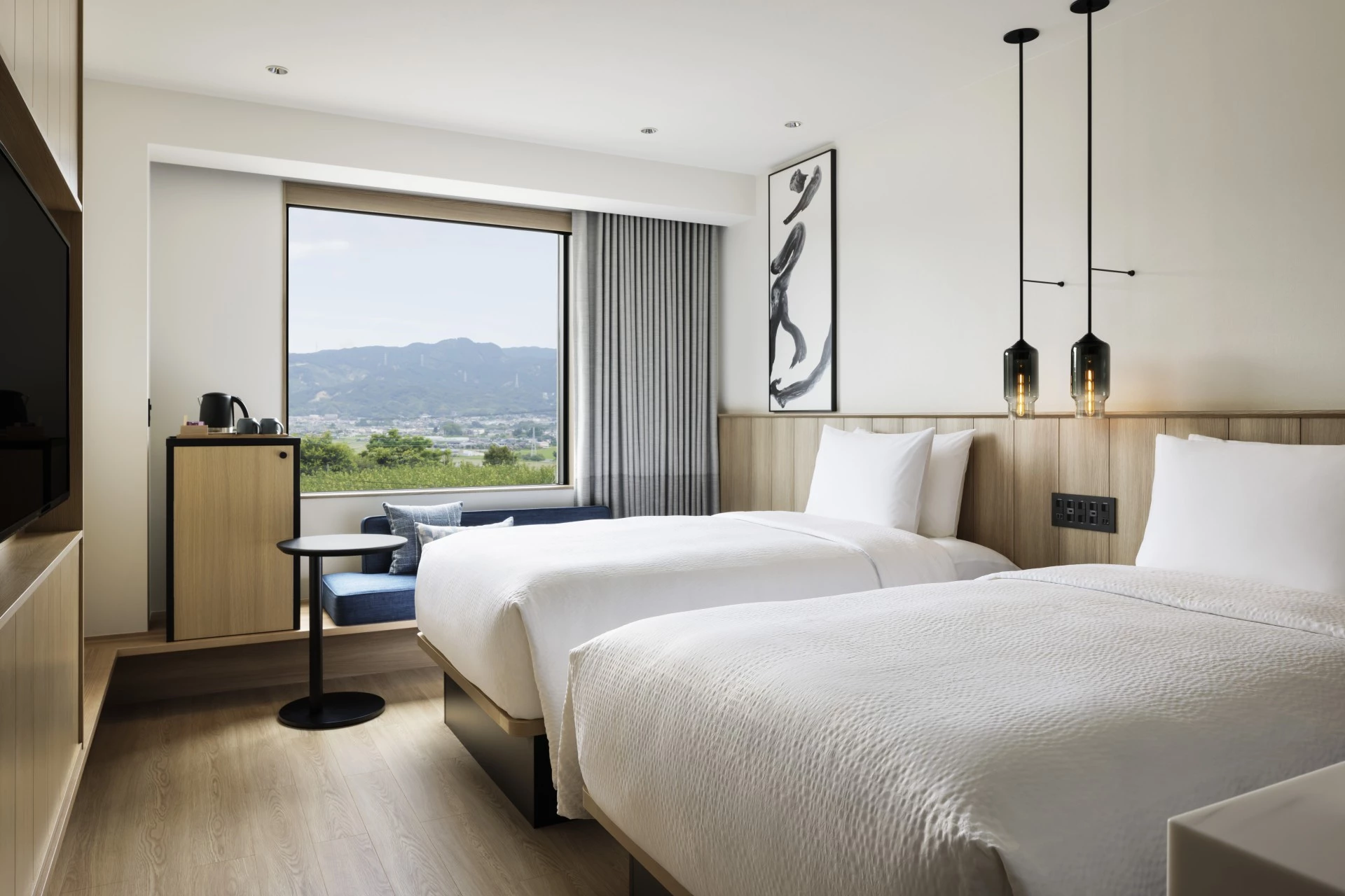 a room with two beds and a window