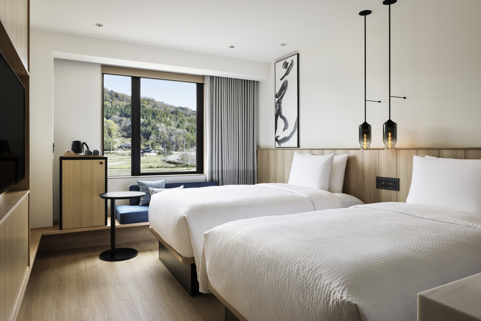 a room with two beds and a window