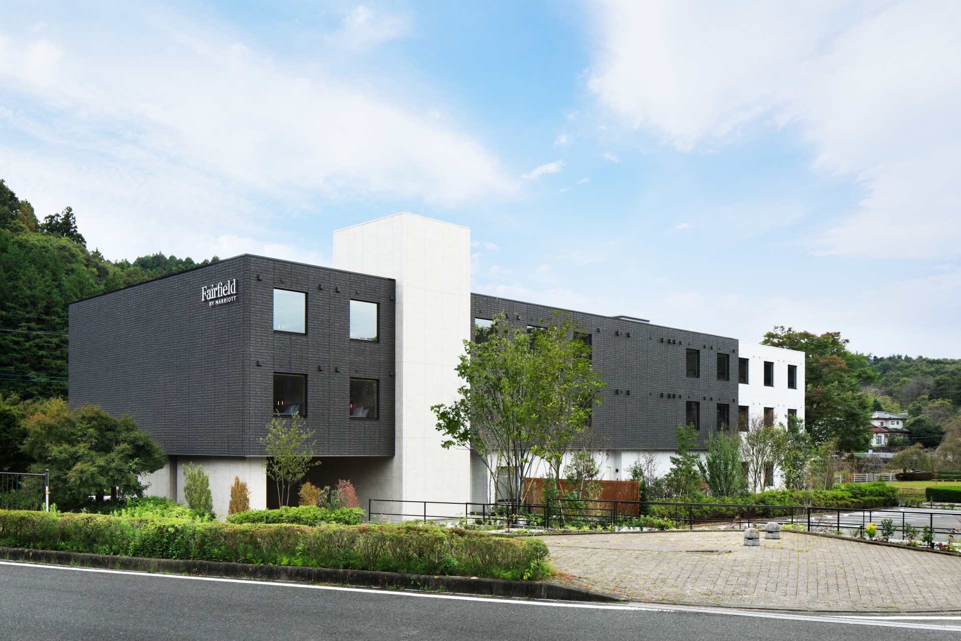a building with trees and a road