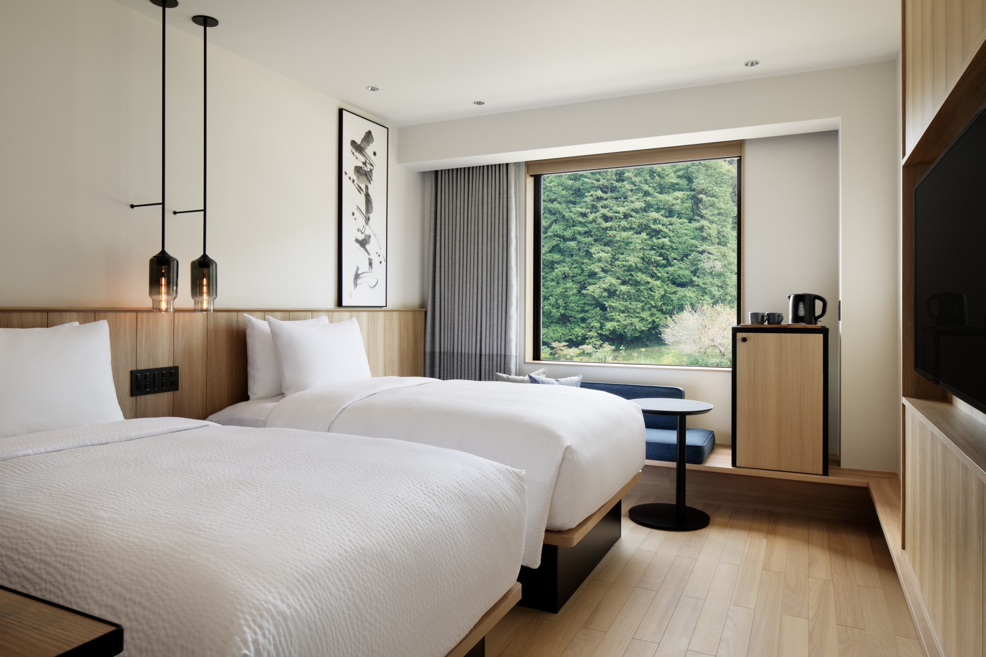 a room with two beds and a window