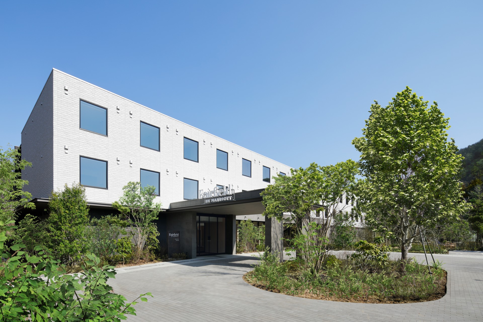 a building with trees and a walkway