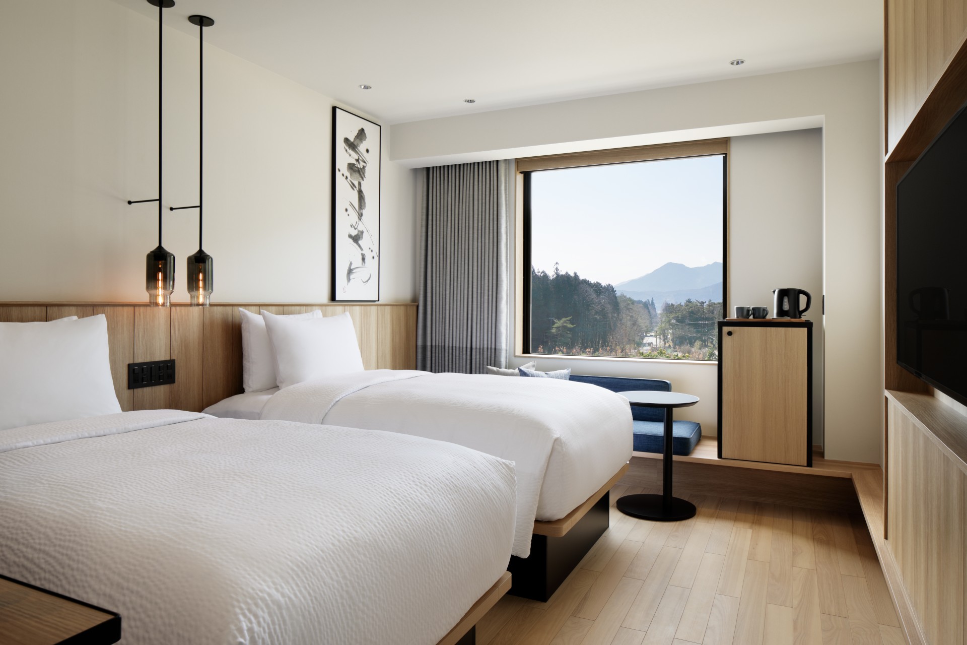 a room with two beds and a window