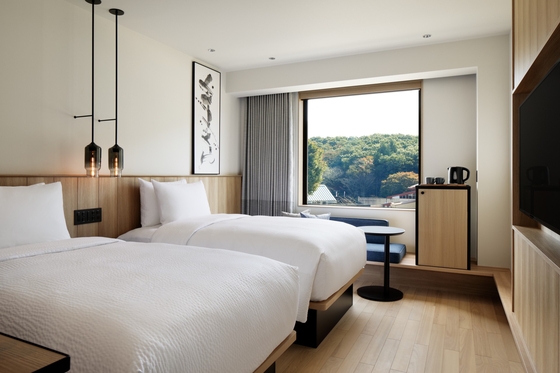 a room with two beds and a window