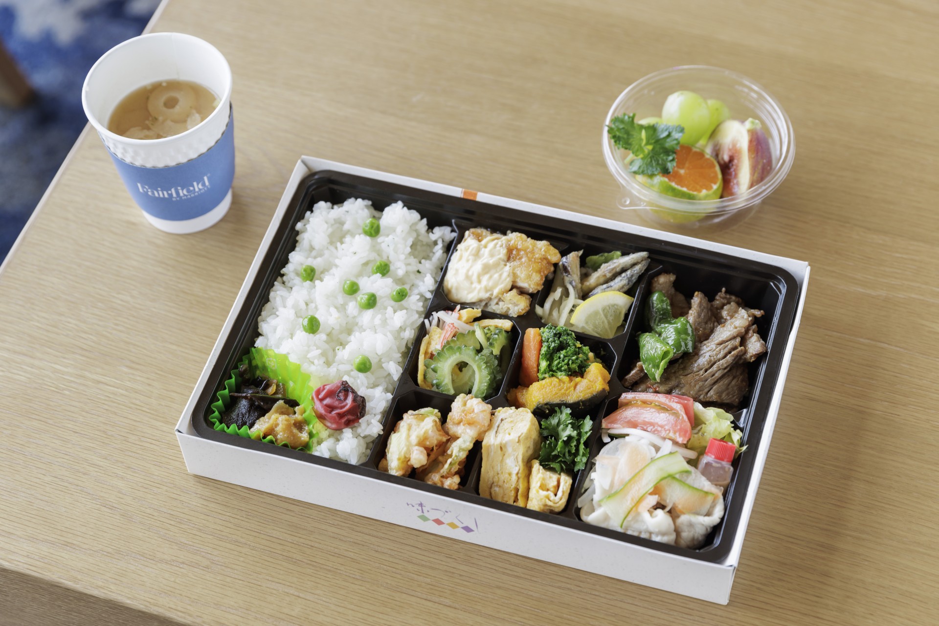a box of food and a cup of coffee