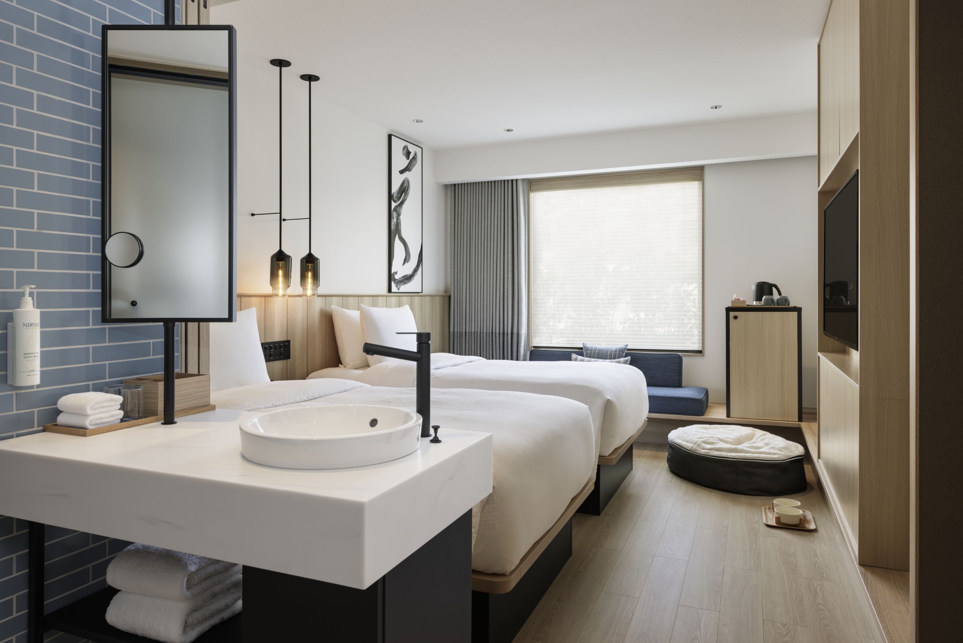 a room with two beds and a sink