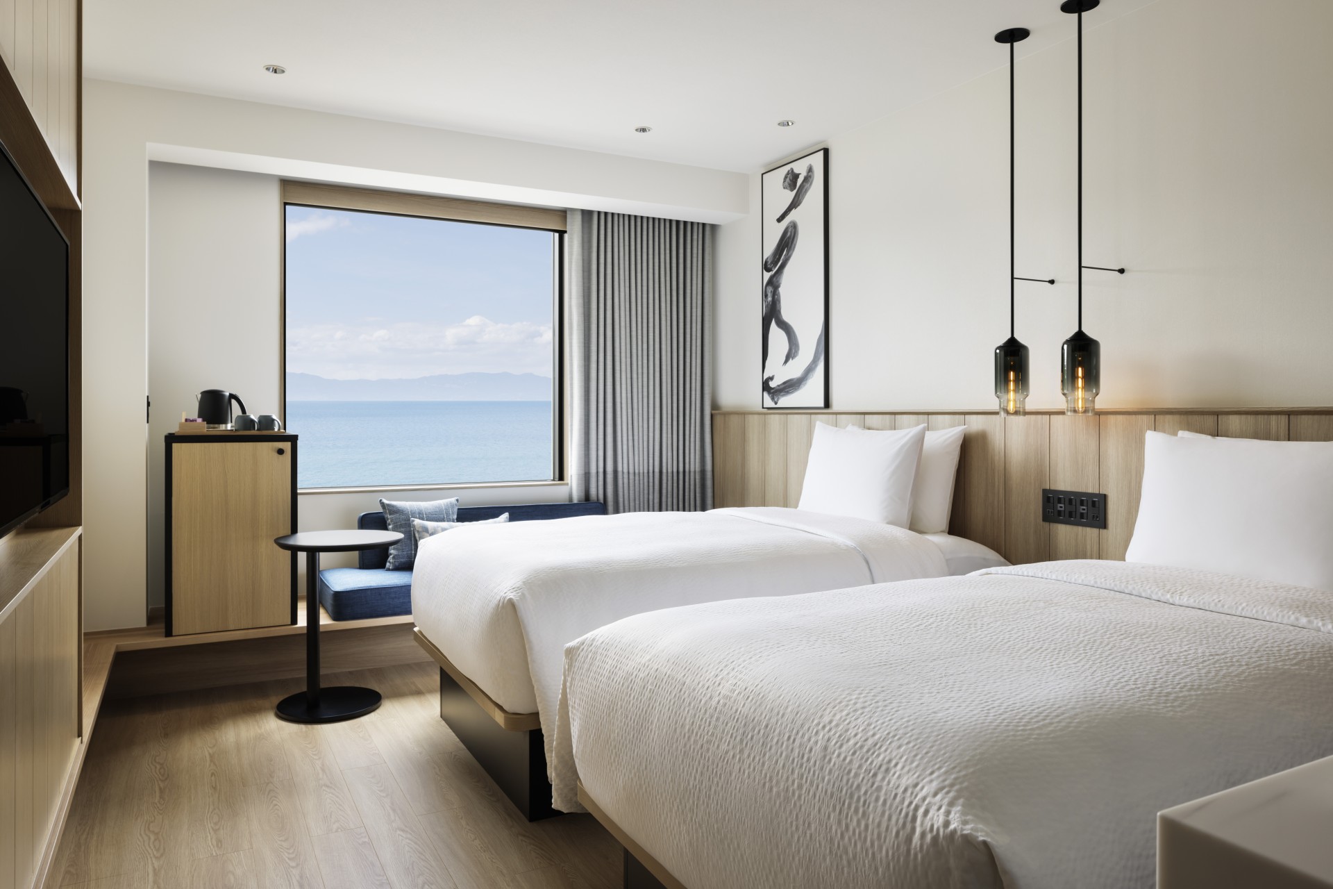a room with two beds and a window