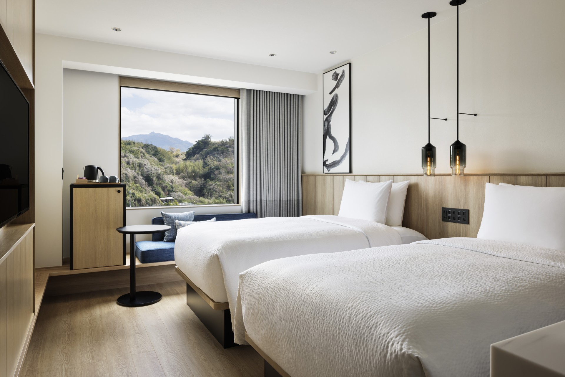 a room with two beds and a window