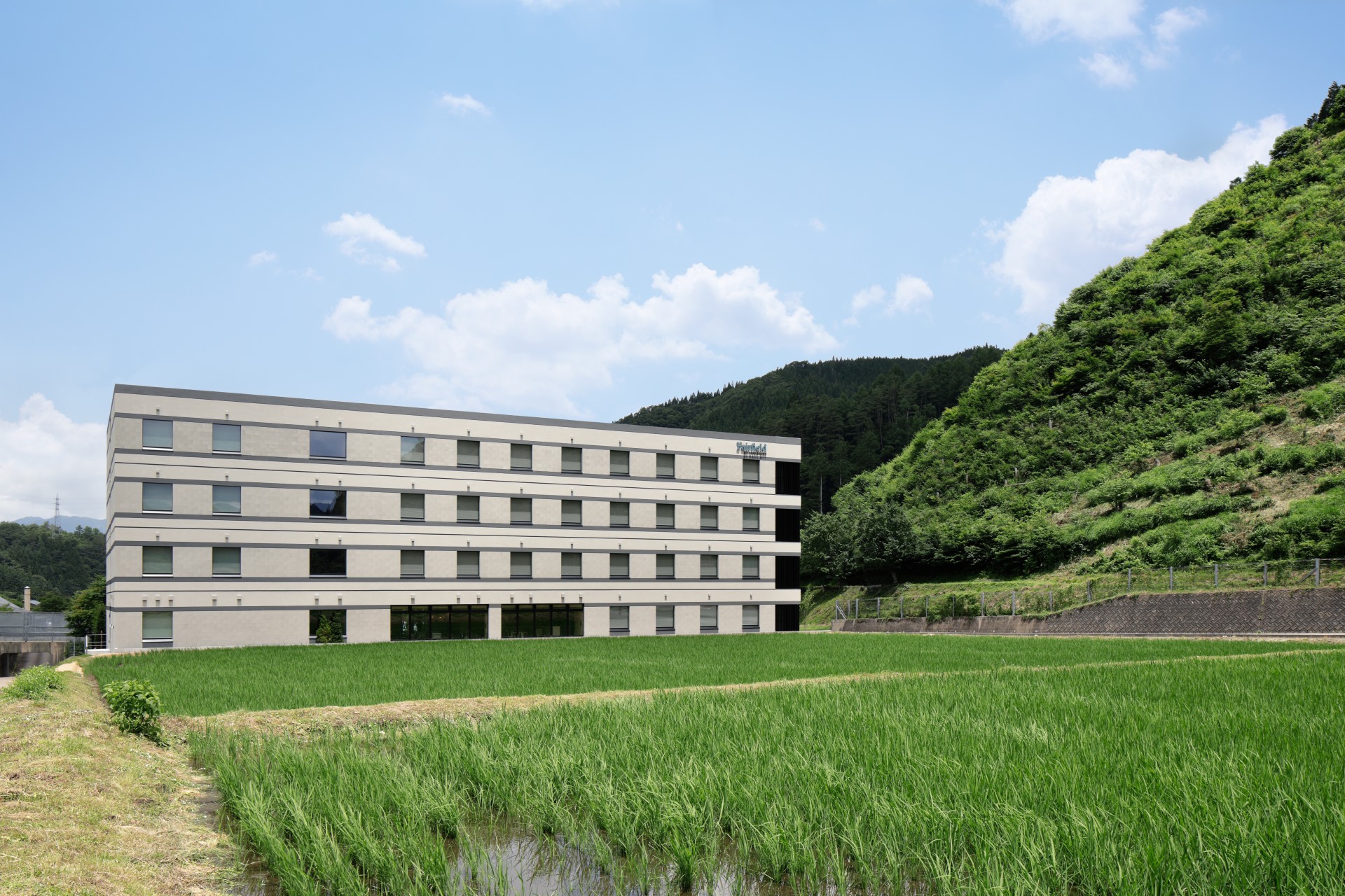 a building with grass and trees in the background