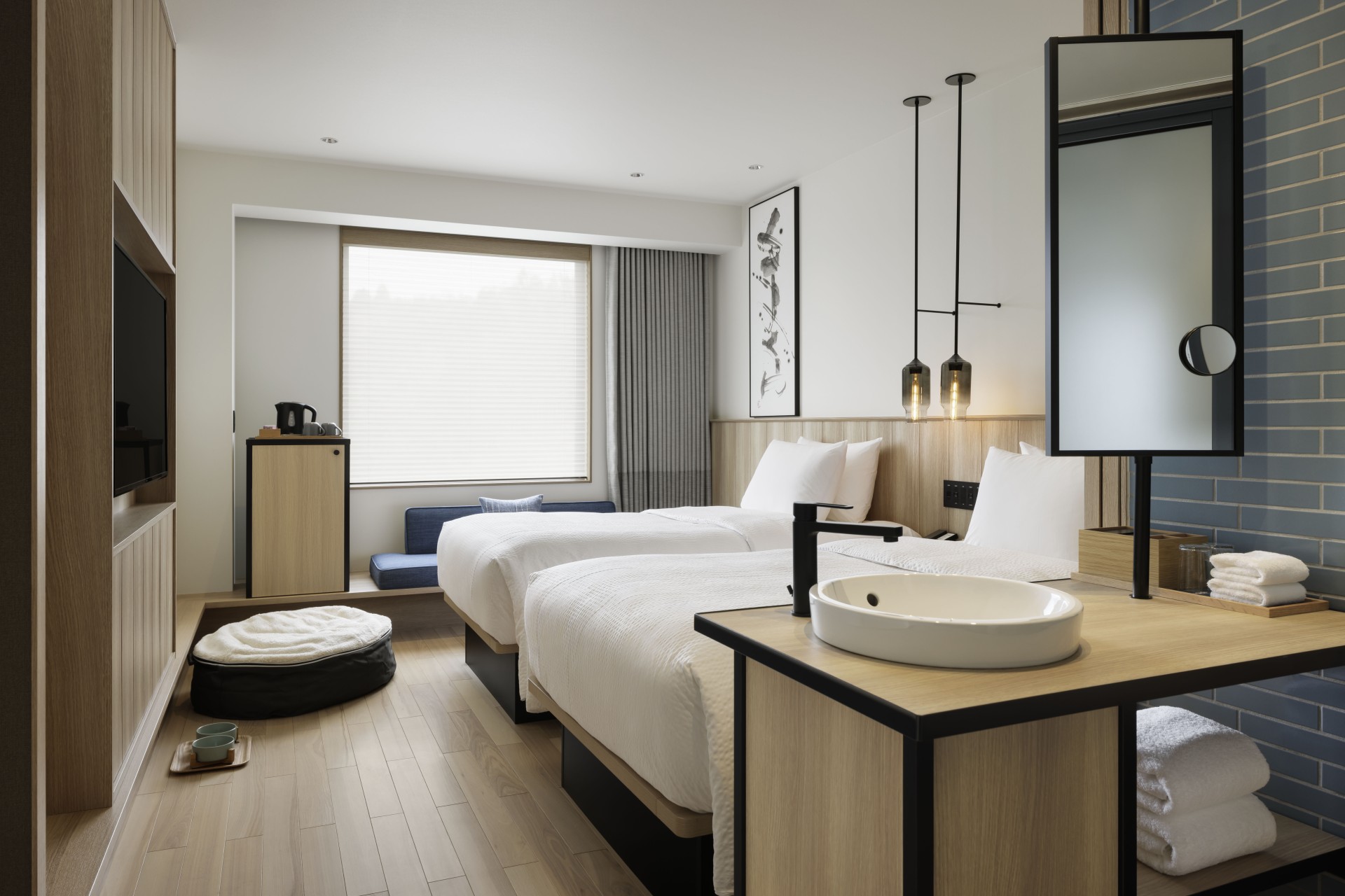 a room with two beds and a sink