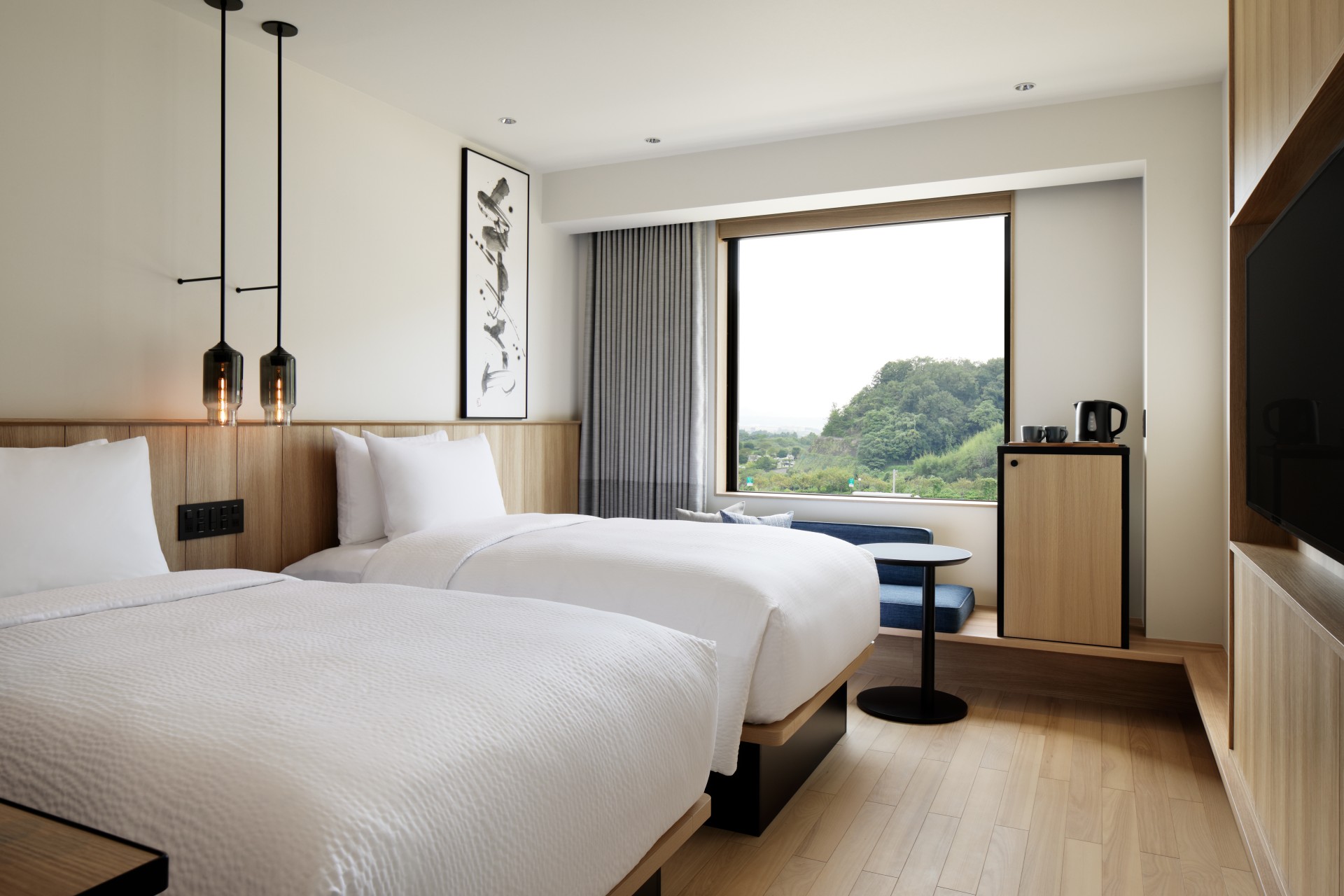 a room with two beds and a window