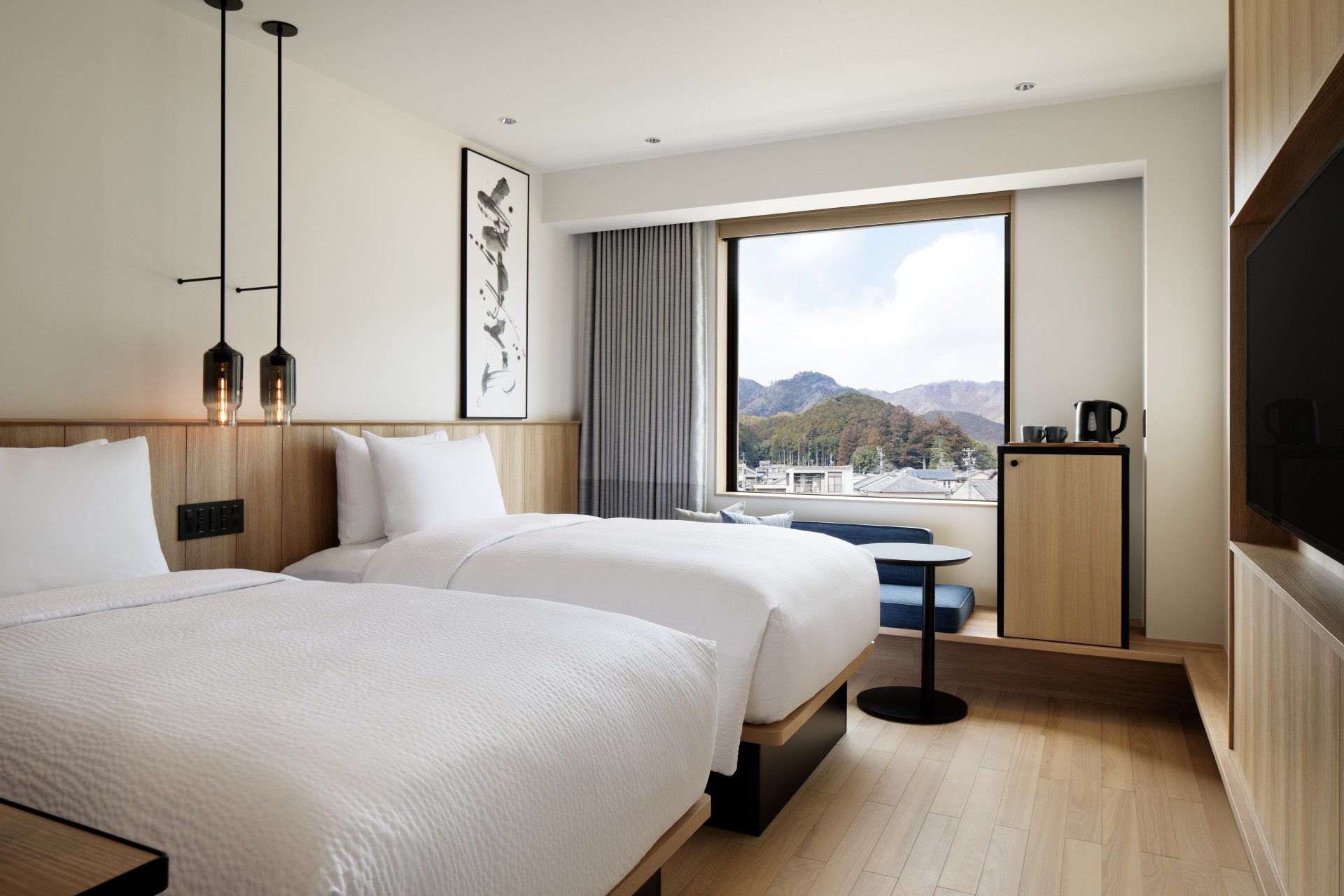 a room with two beds and a window