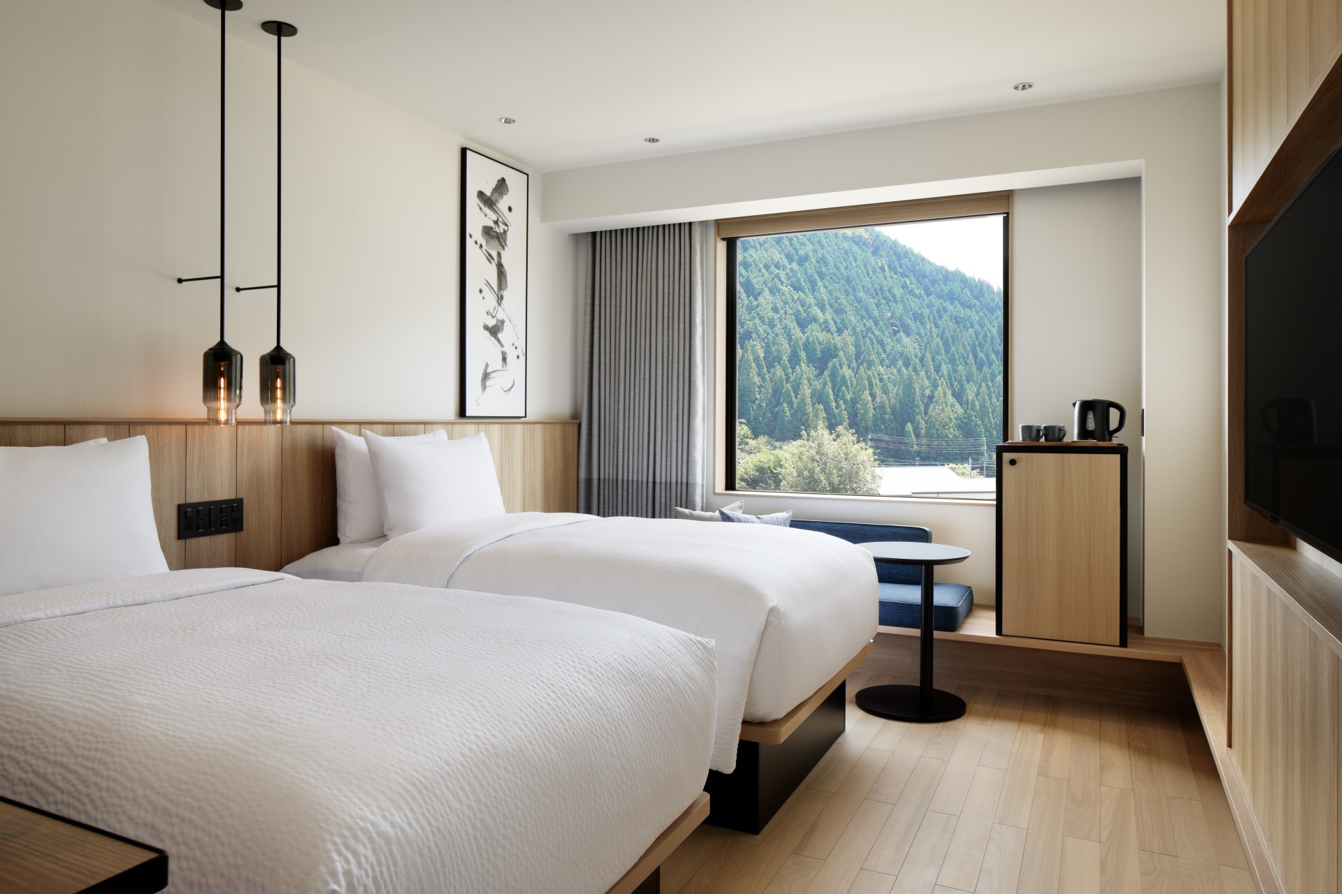 a room with two beds and a window