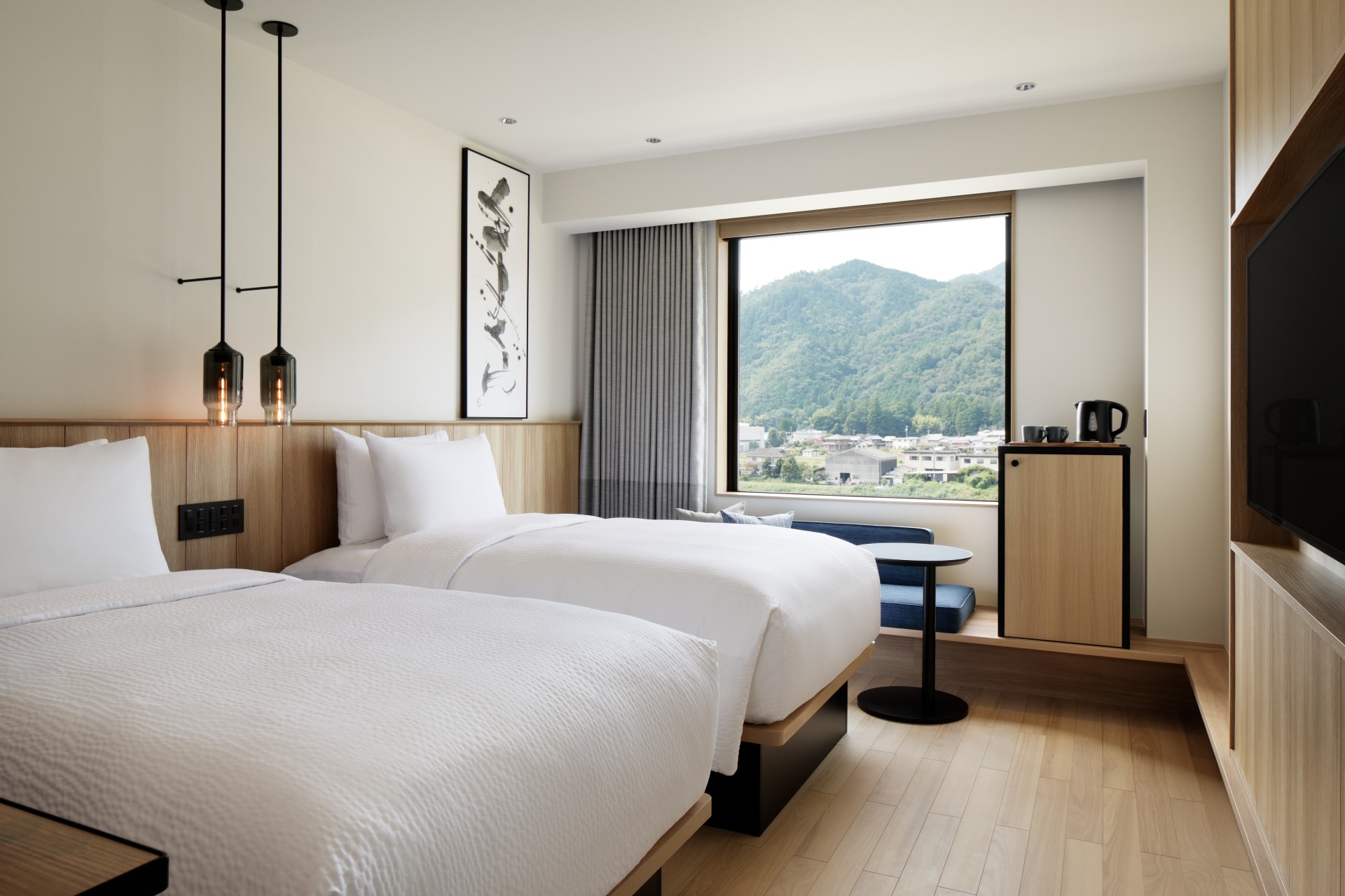a room with two beds and a window