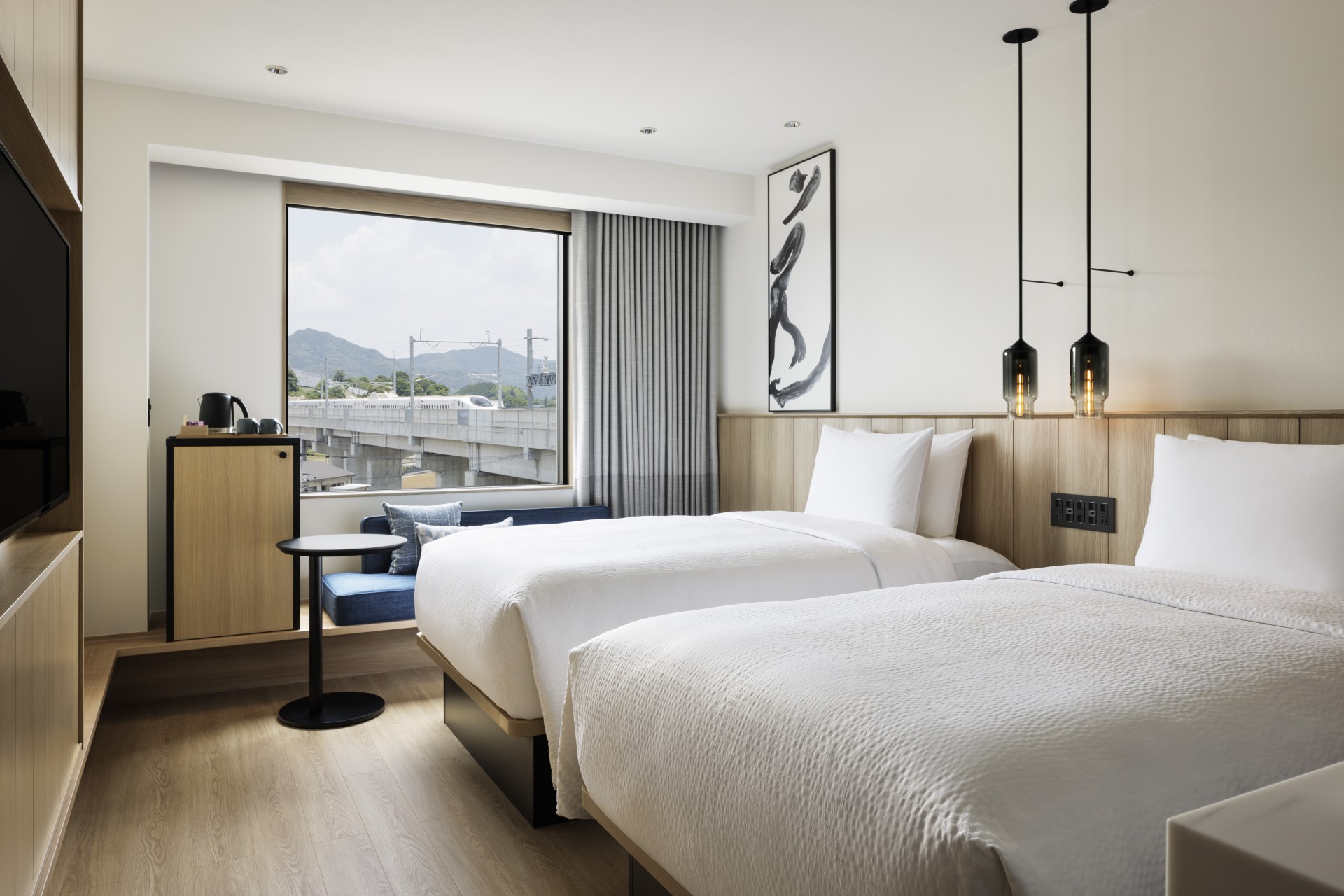 a room with two beds and a window