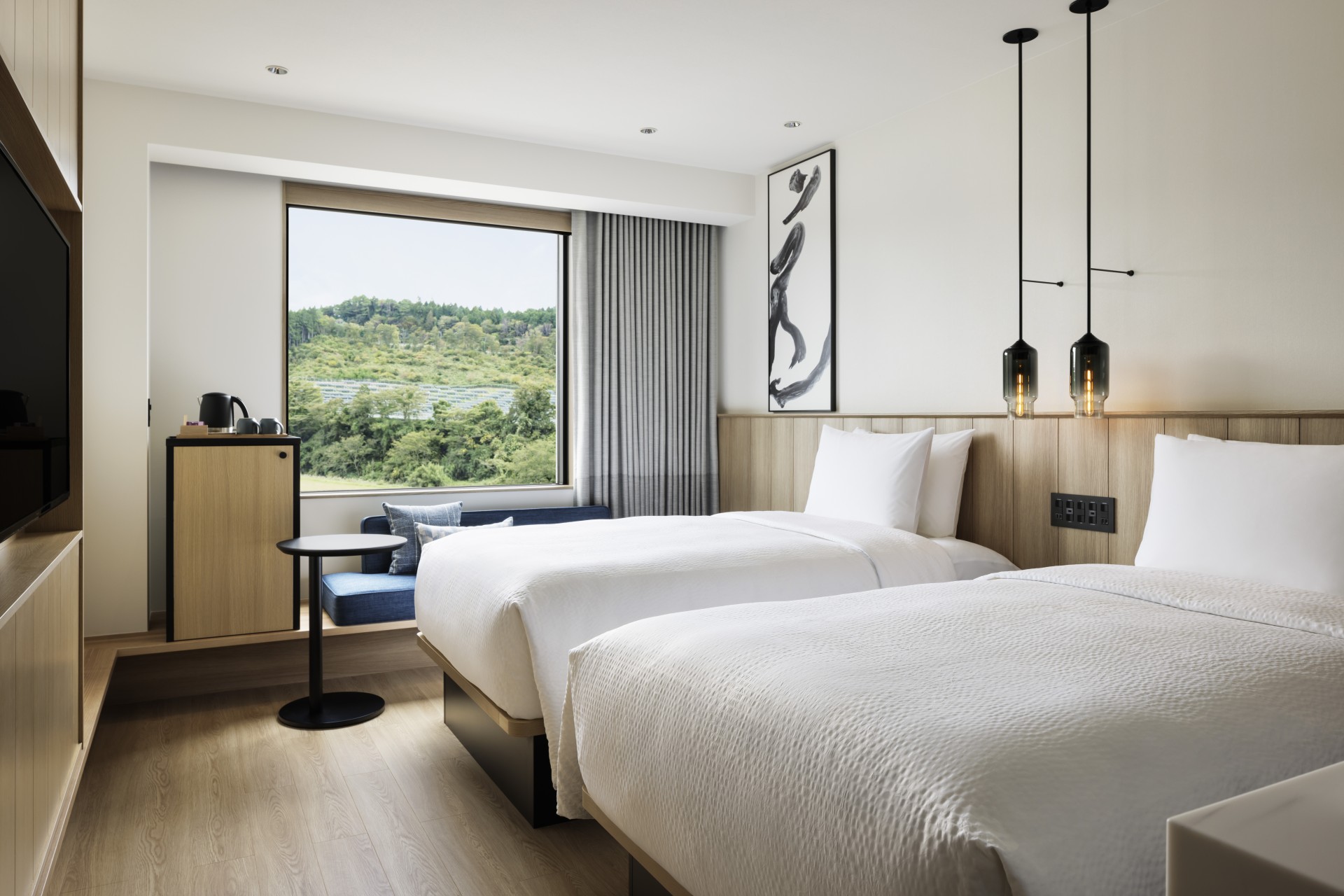 a room with two beds and a window