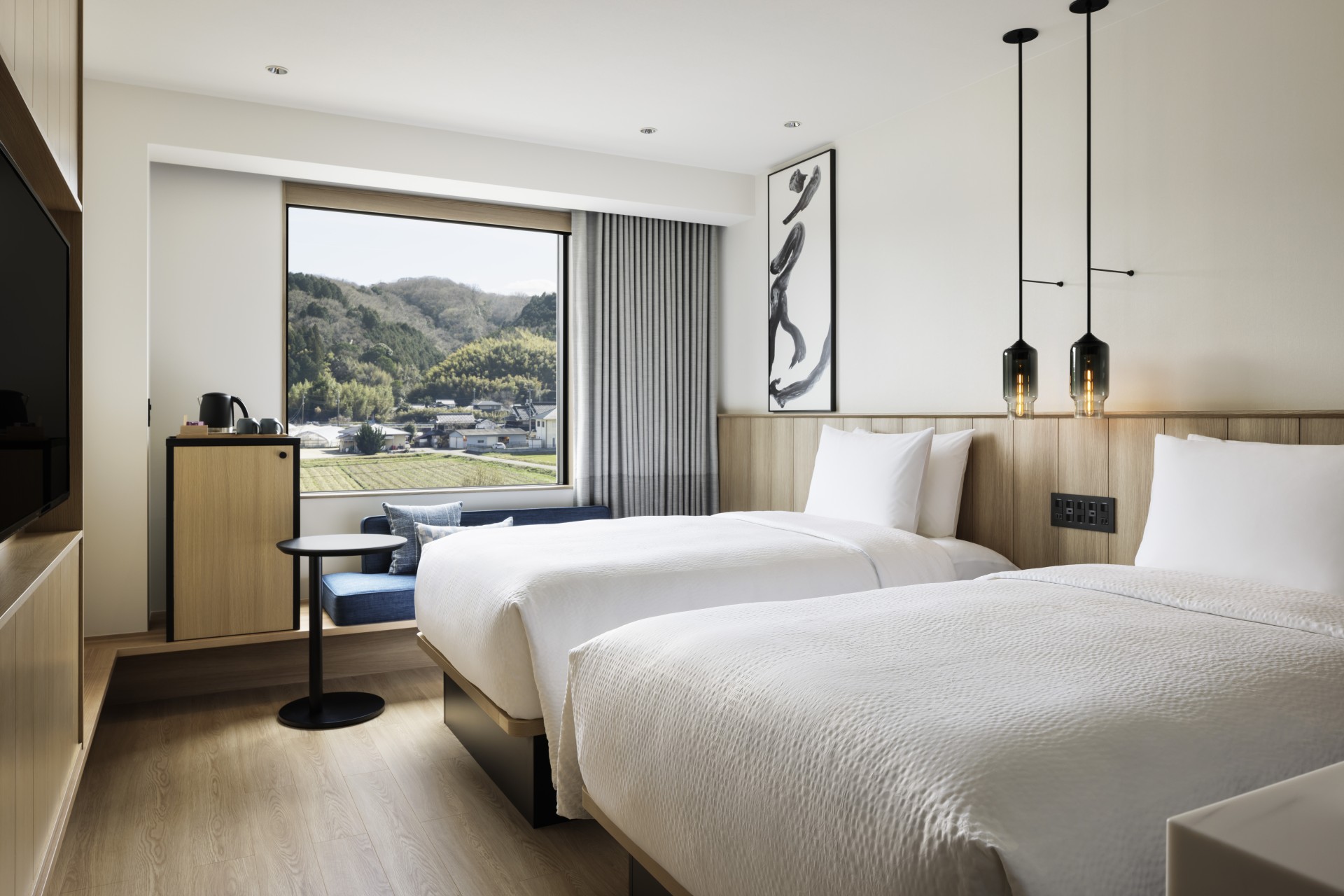 a room with two beds and a window