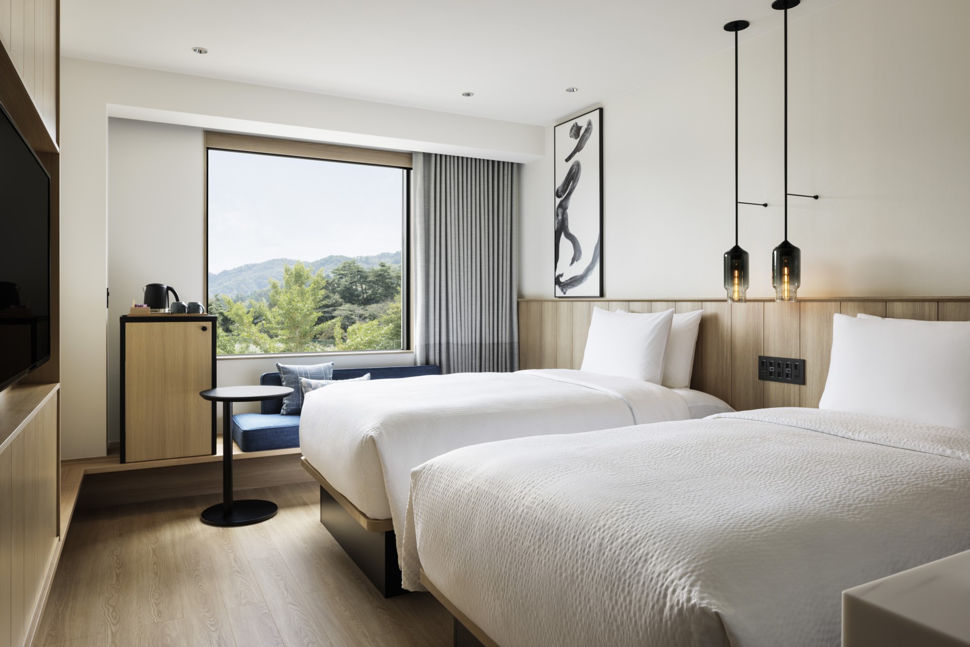 a room with two beds and a window