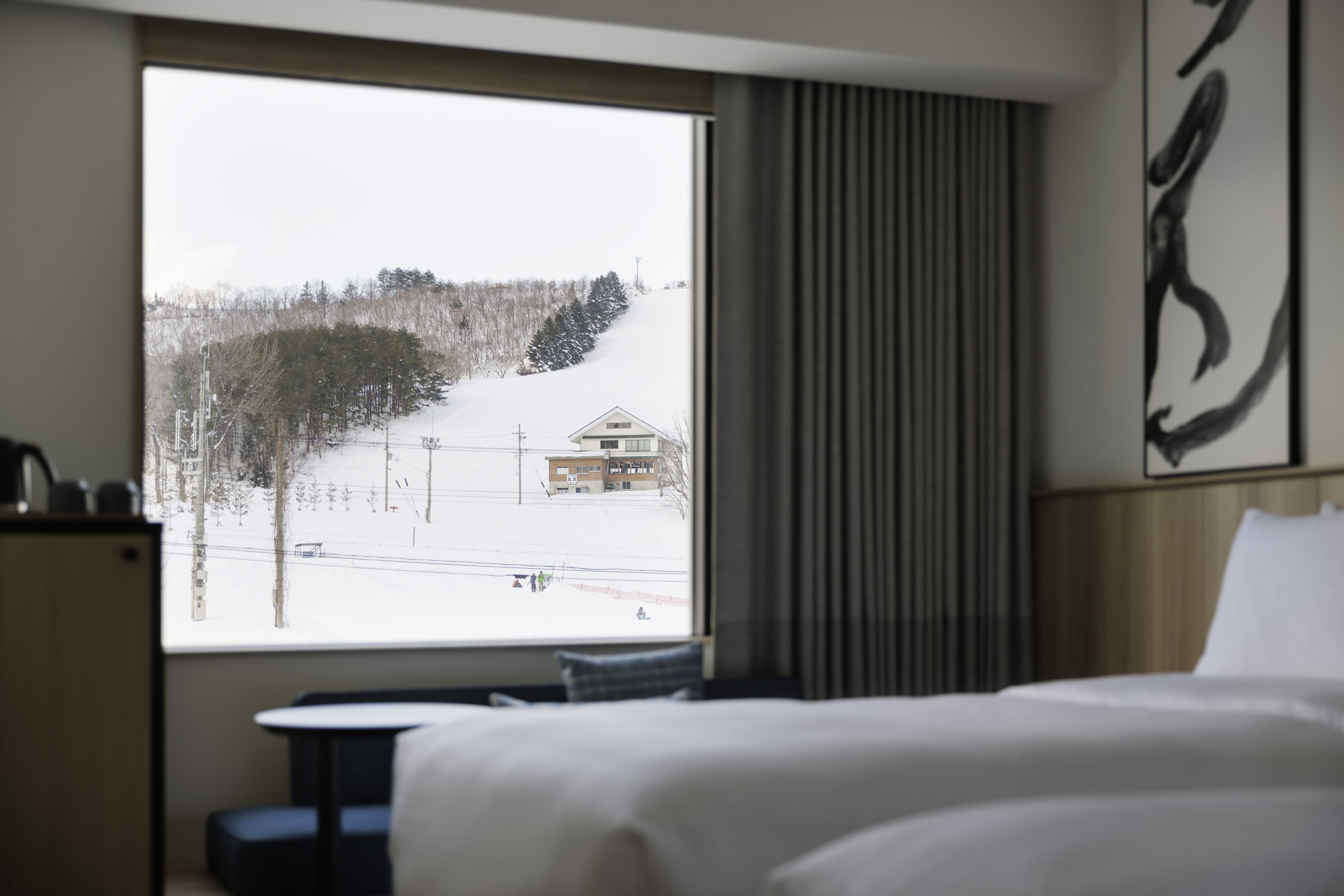 a room with a window and a snowy mountain