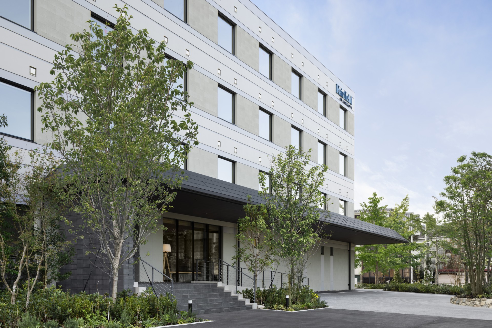 a building with trees and a walkway