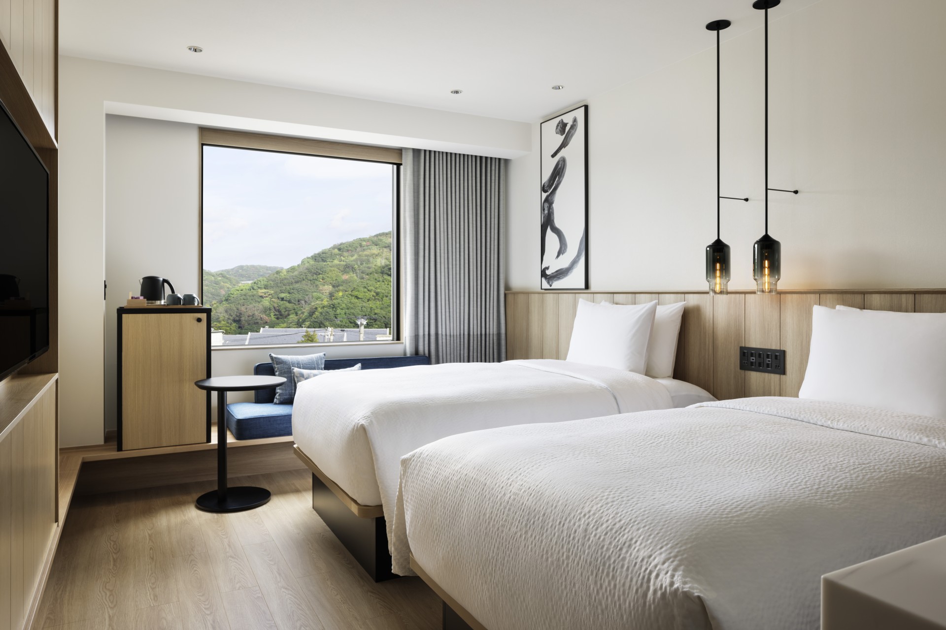 a room with two beds and a window