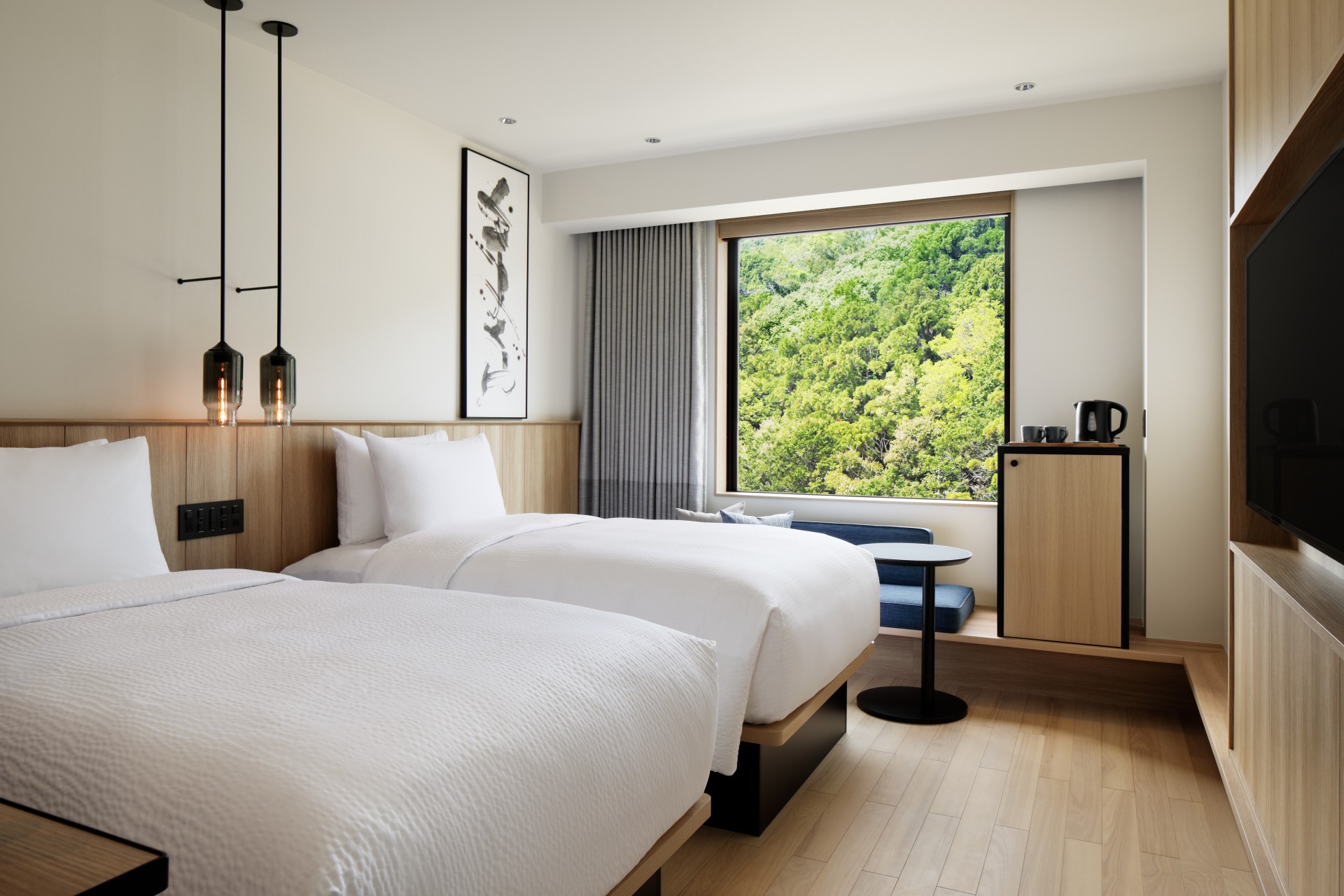 a room with two beds and a window