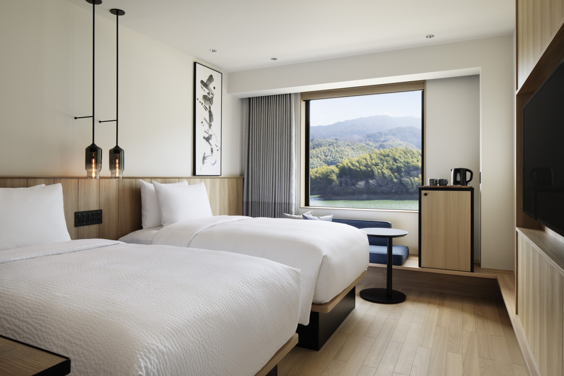 a room with two beds and a window