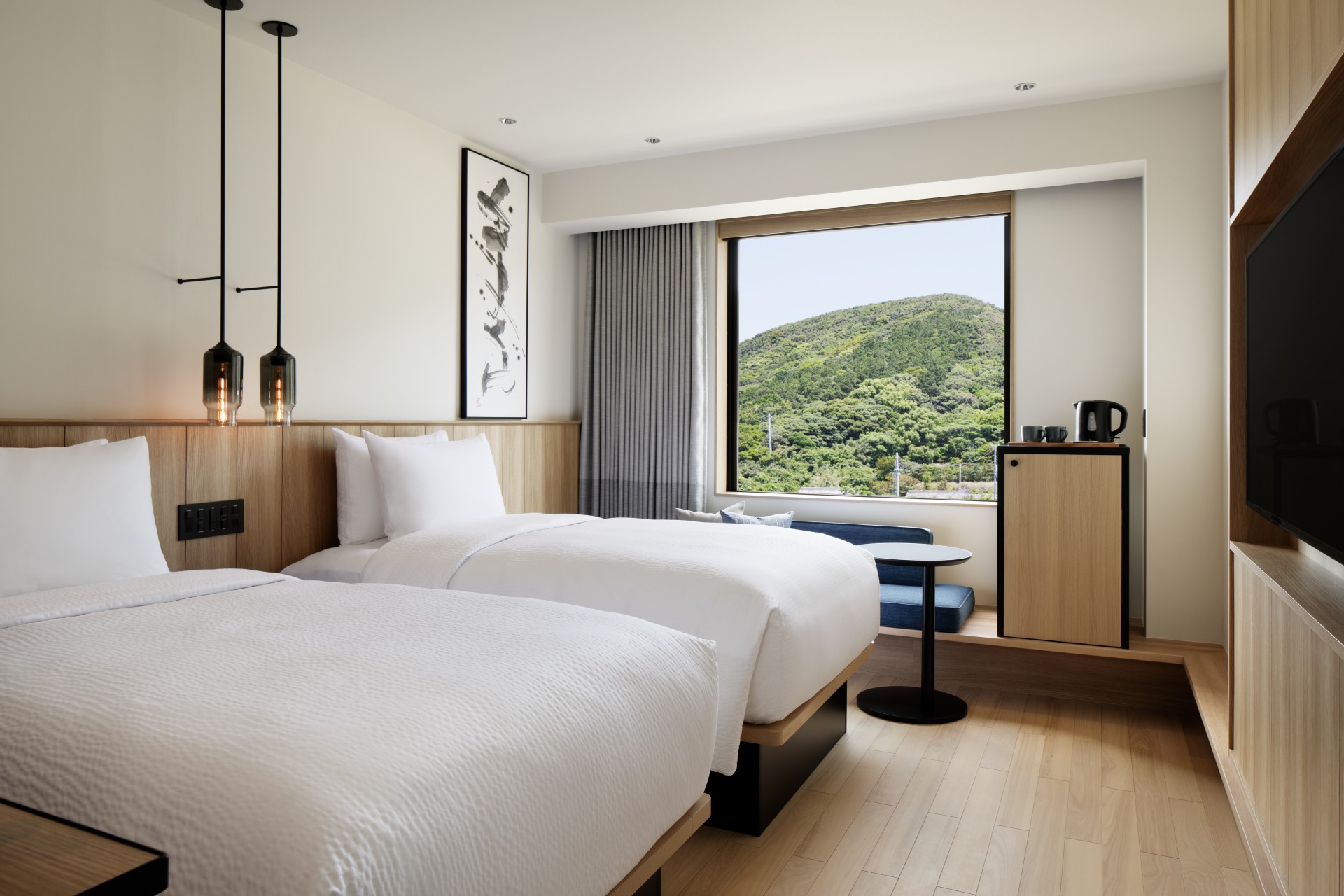 a room with two beds and a window