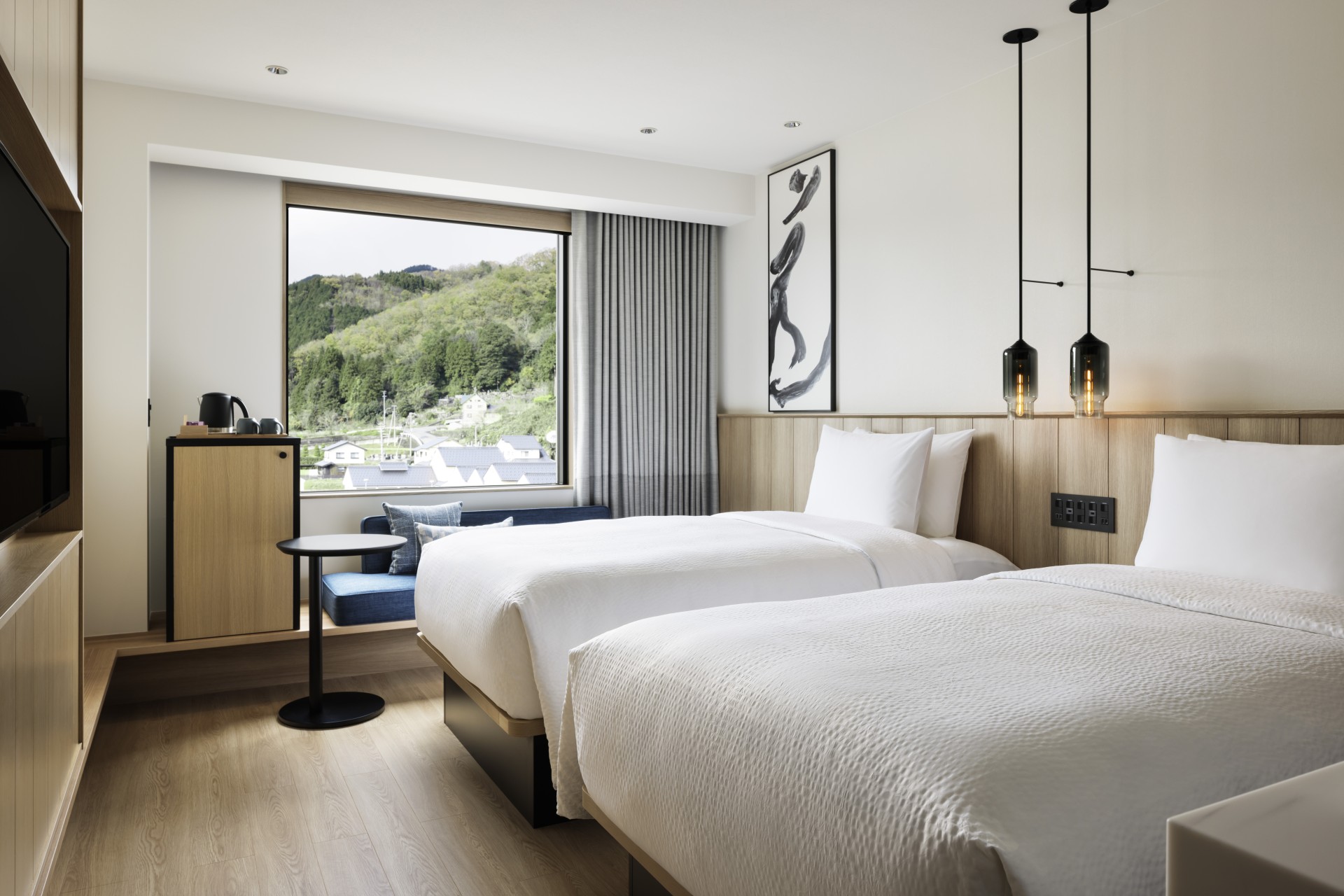 a room with two beds and a window