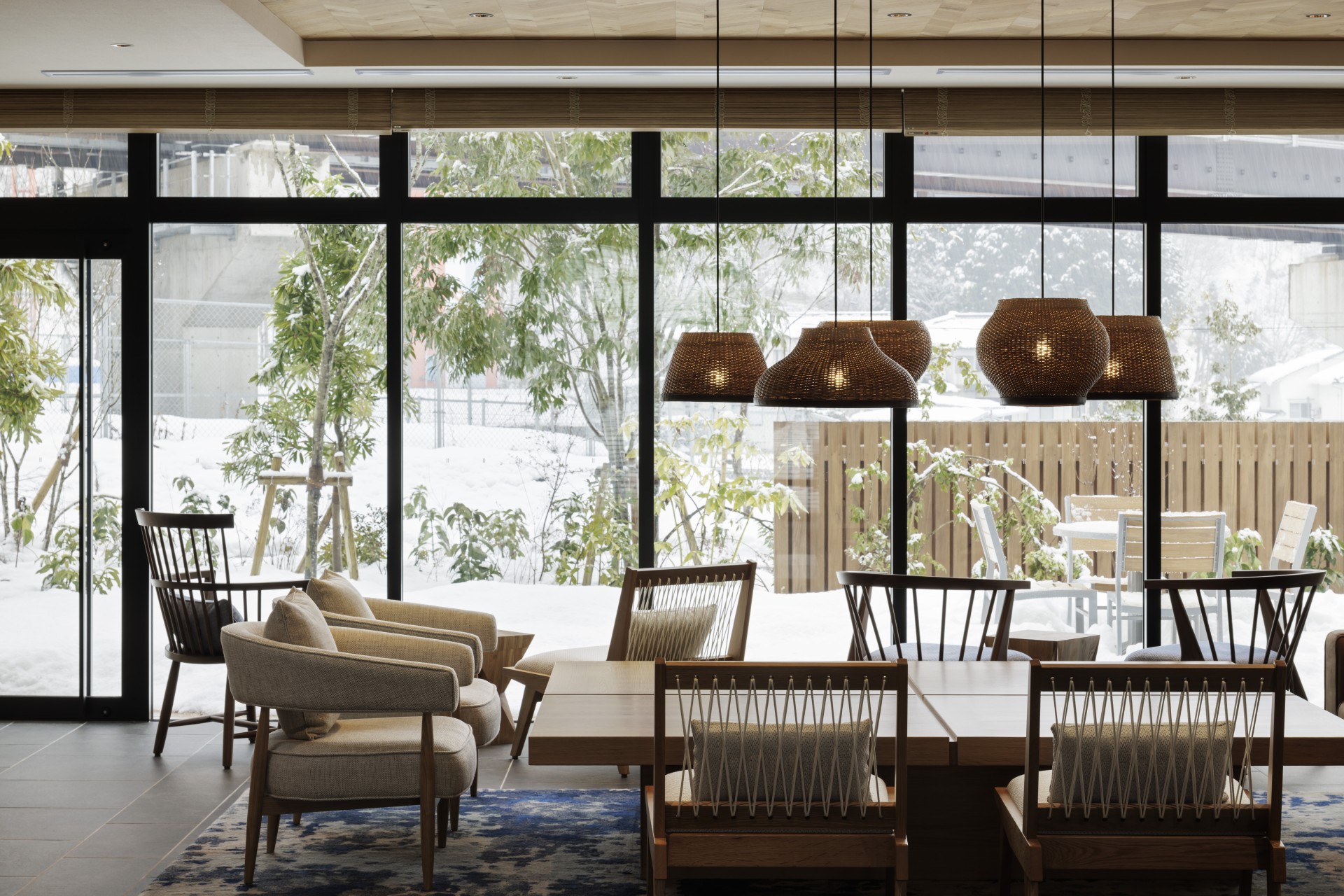 a room with a table and chairs and a large window