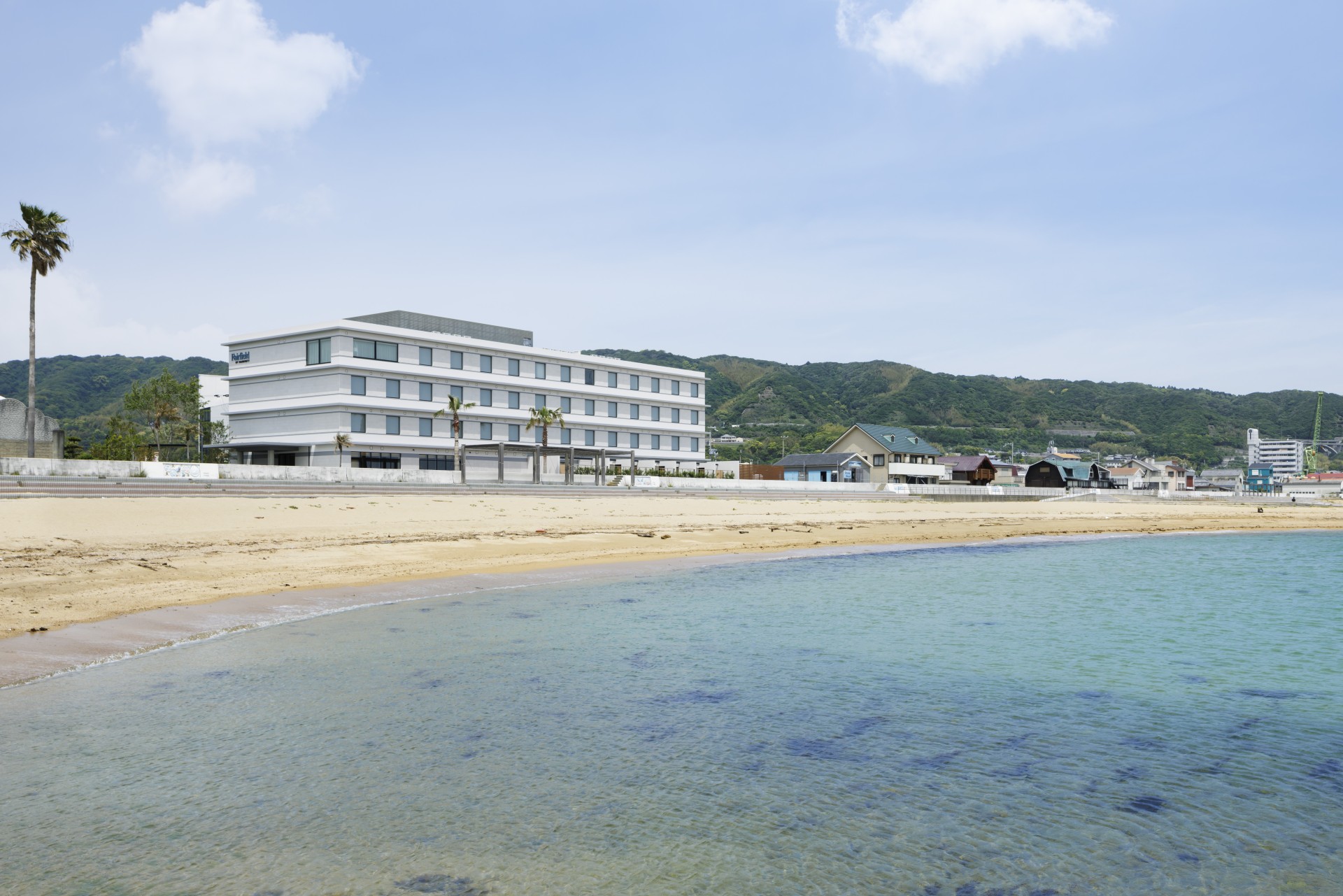 a beach with buildings and a body of water