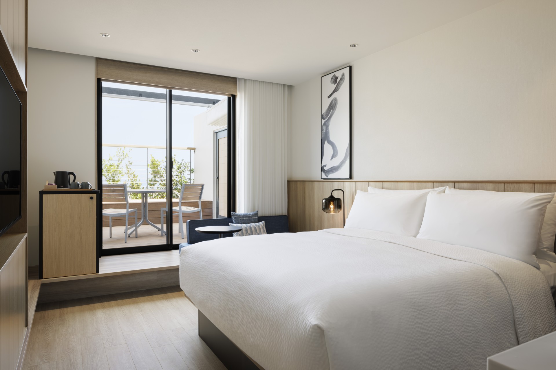 a bed with a glass door and a table