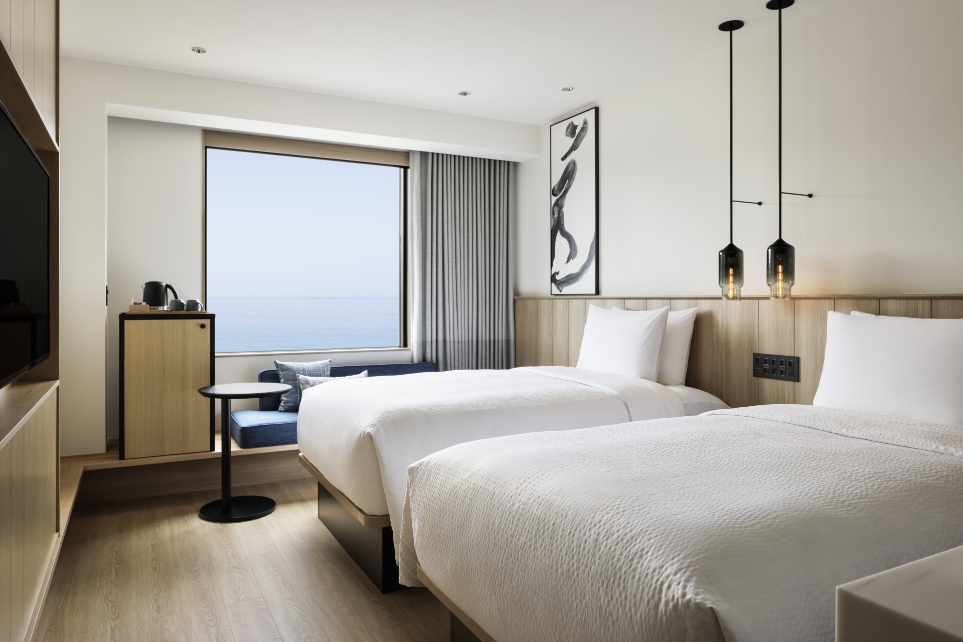 a room with two beds and a window