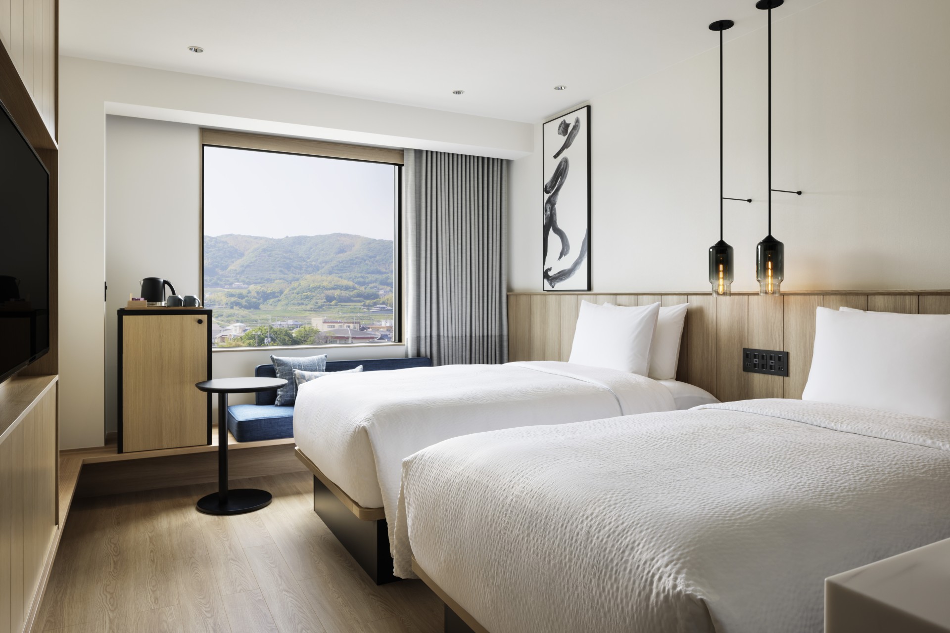a room with two beds and a window