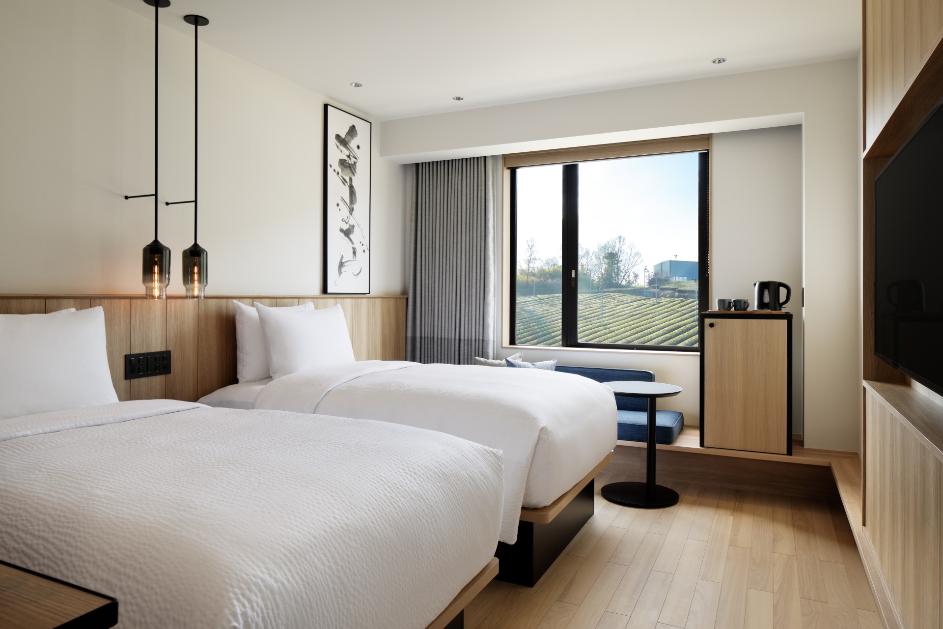 a room with two beds and a window