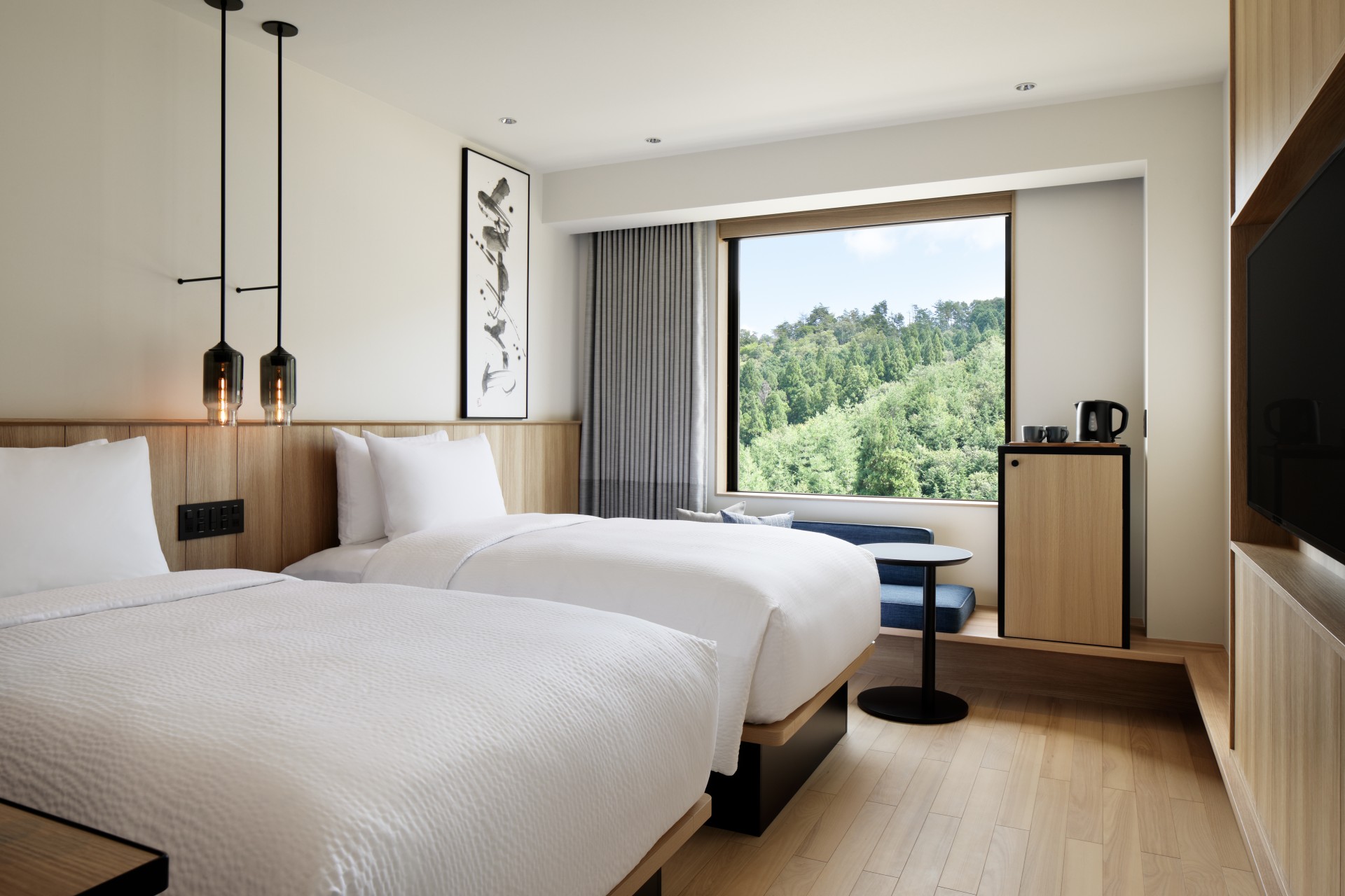 a room with two beds and a window
