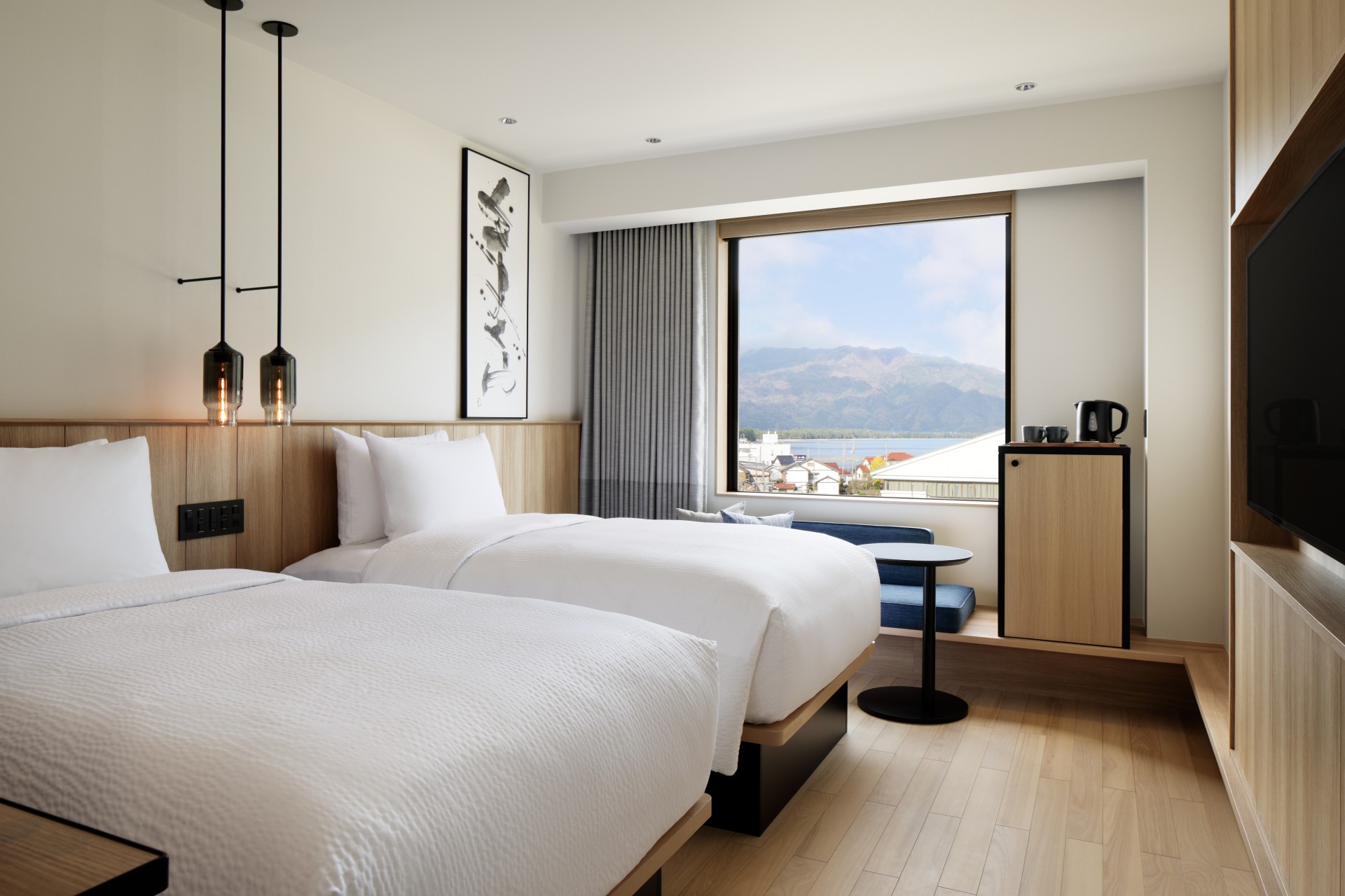 a room with two beds and a window