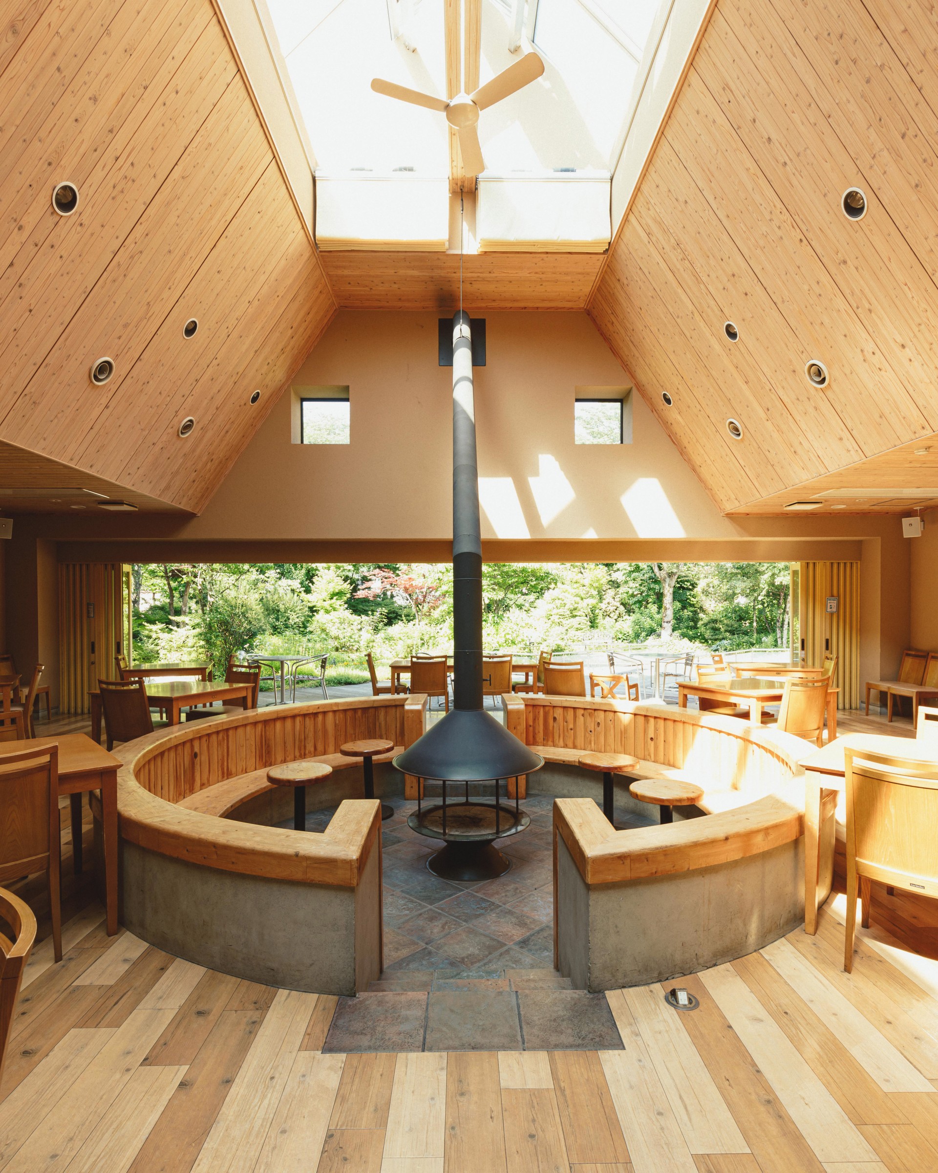 a room with a fireplace and tables
